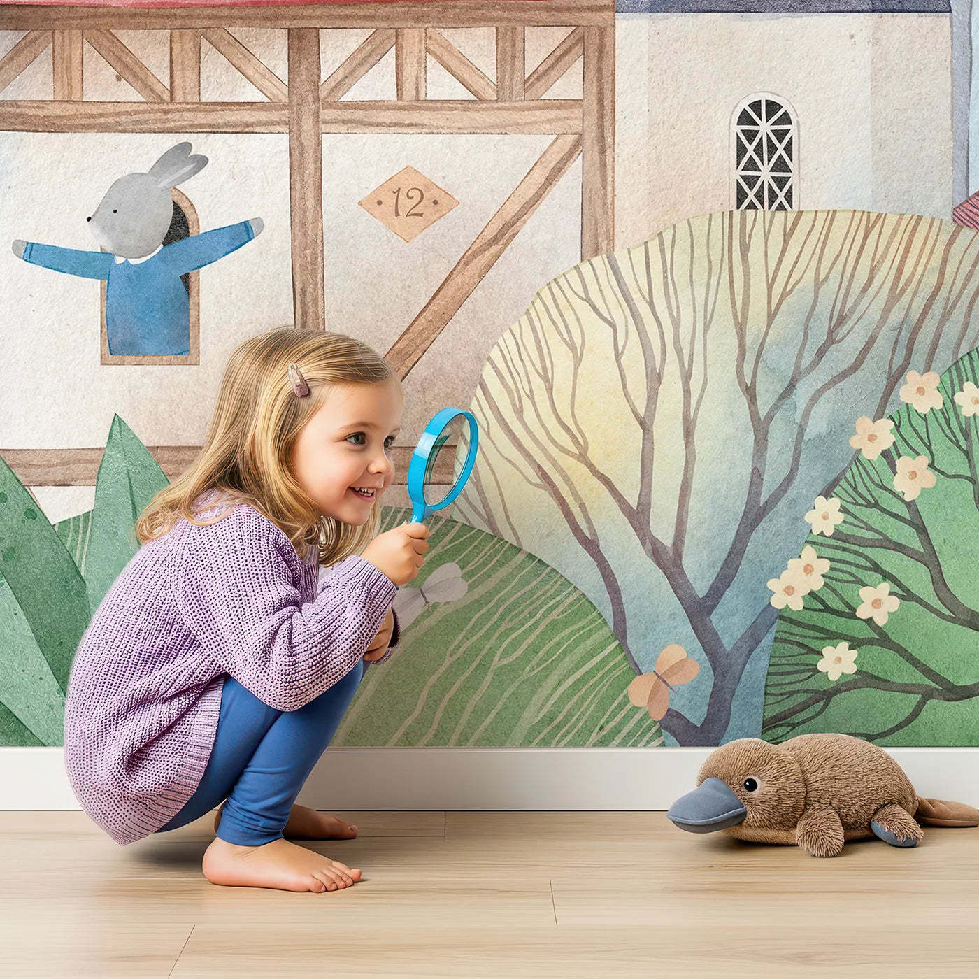 Child in front of Whimsy Tots Rabbit Castle Wall Mural with castle, rabbit, watercolor, whimsical, village, medieval, cute, storybook in design.