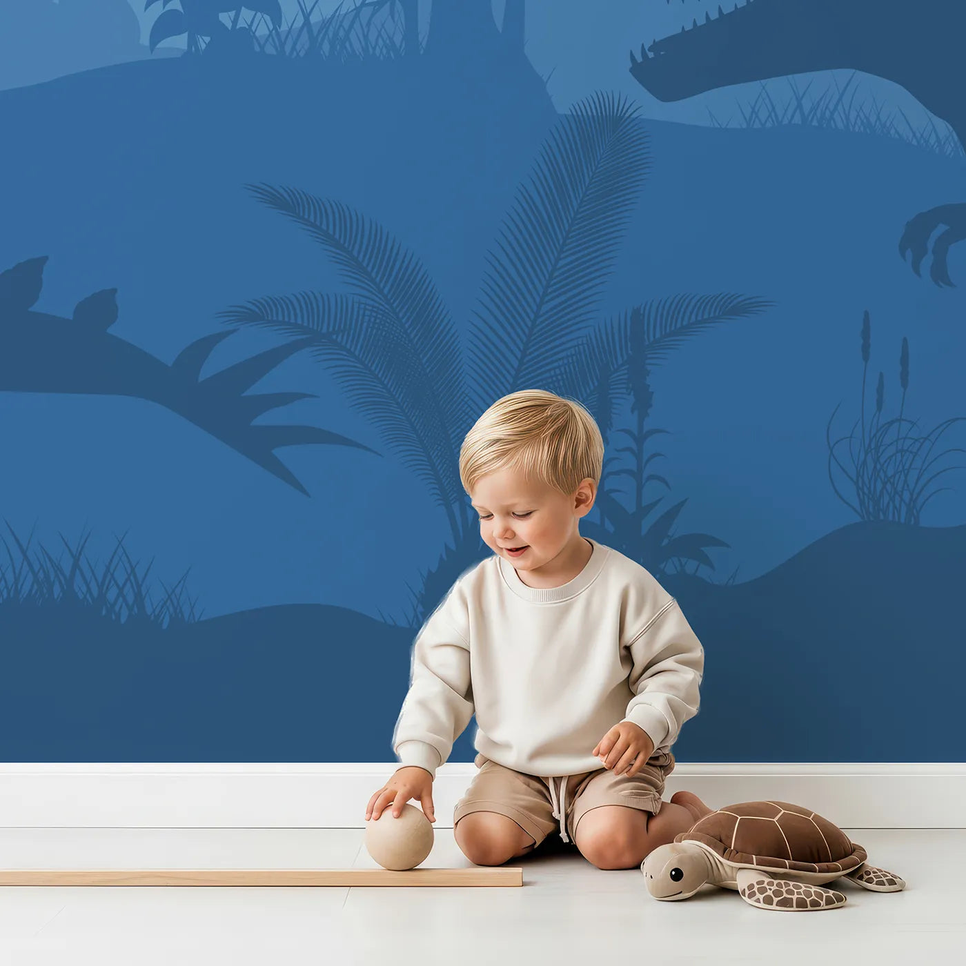 Child in front of Whimsy Tots Dinosaur Sunset Silhouette Wall Mural with dinosaur, silhouette, sunset, prehistoric, jungle, volcano, blue, pink in design.