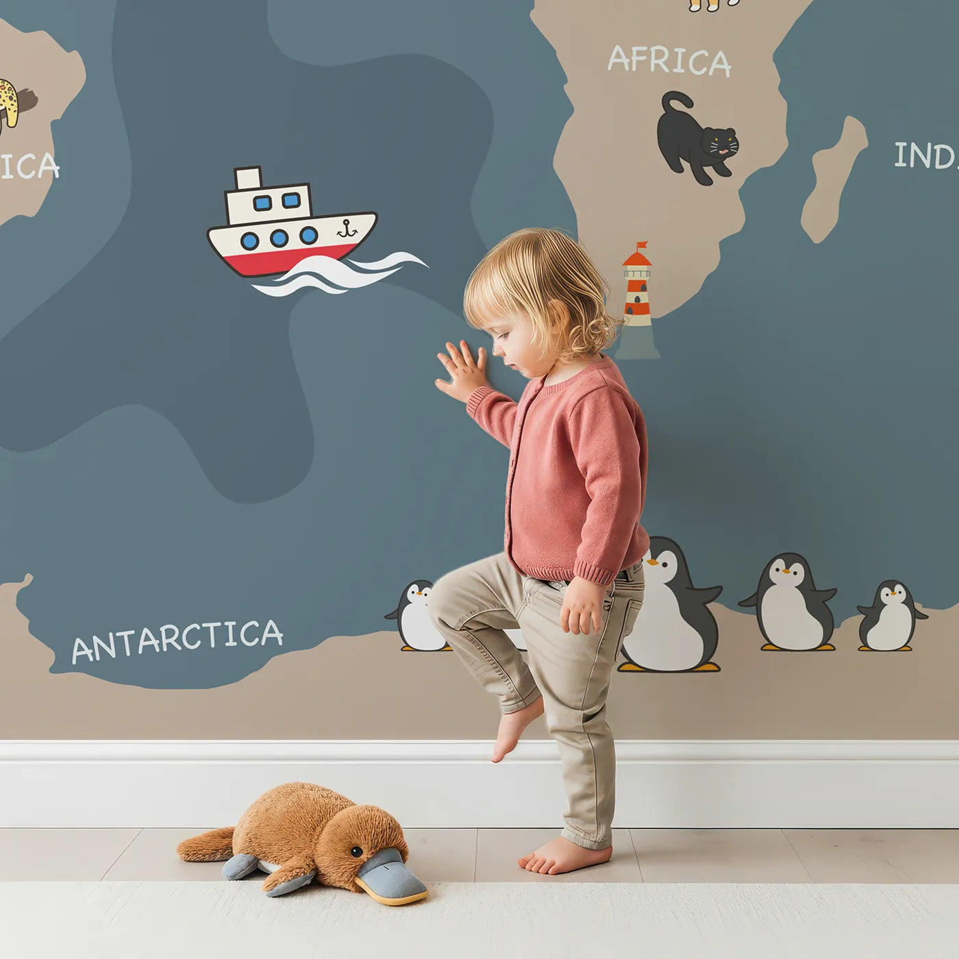 Child in front of Whimsy Tots Nighttime Animal World Map Wall Mural in Gray with map, world, animal, cute, educational, cartoon, night, ocean in design.