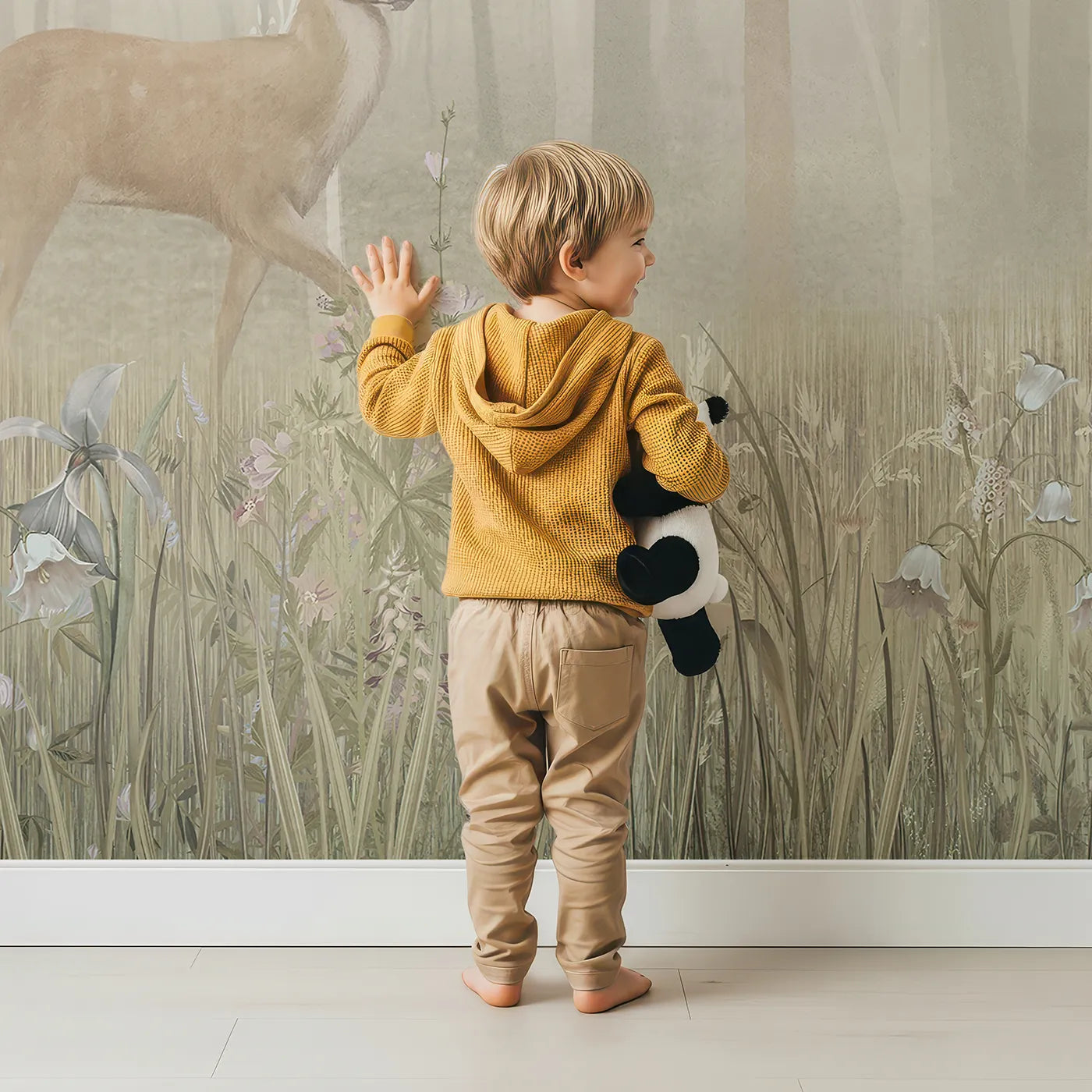 Child in front of Whimsy Tots Misty Blossom Forest Stag Wall Mural with woodland, animal, forest, blossom, pink, deer, stag, mist in design.