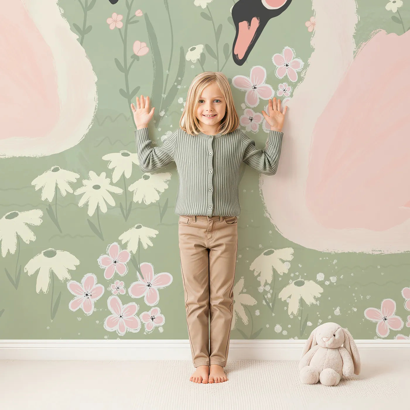 Child in front of Whimsy Tots Pink Swan Lake Wall Mural with swan, pink, flower, pond, romantic, painterly, bird, nature in design.