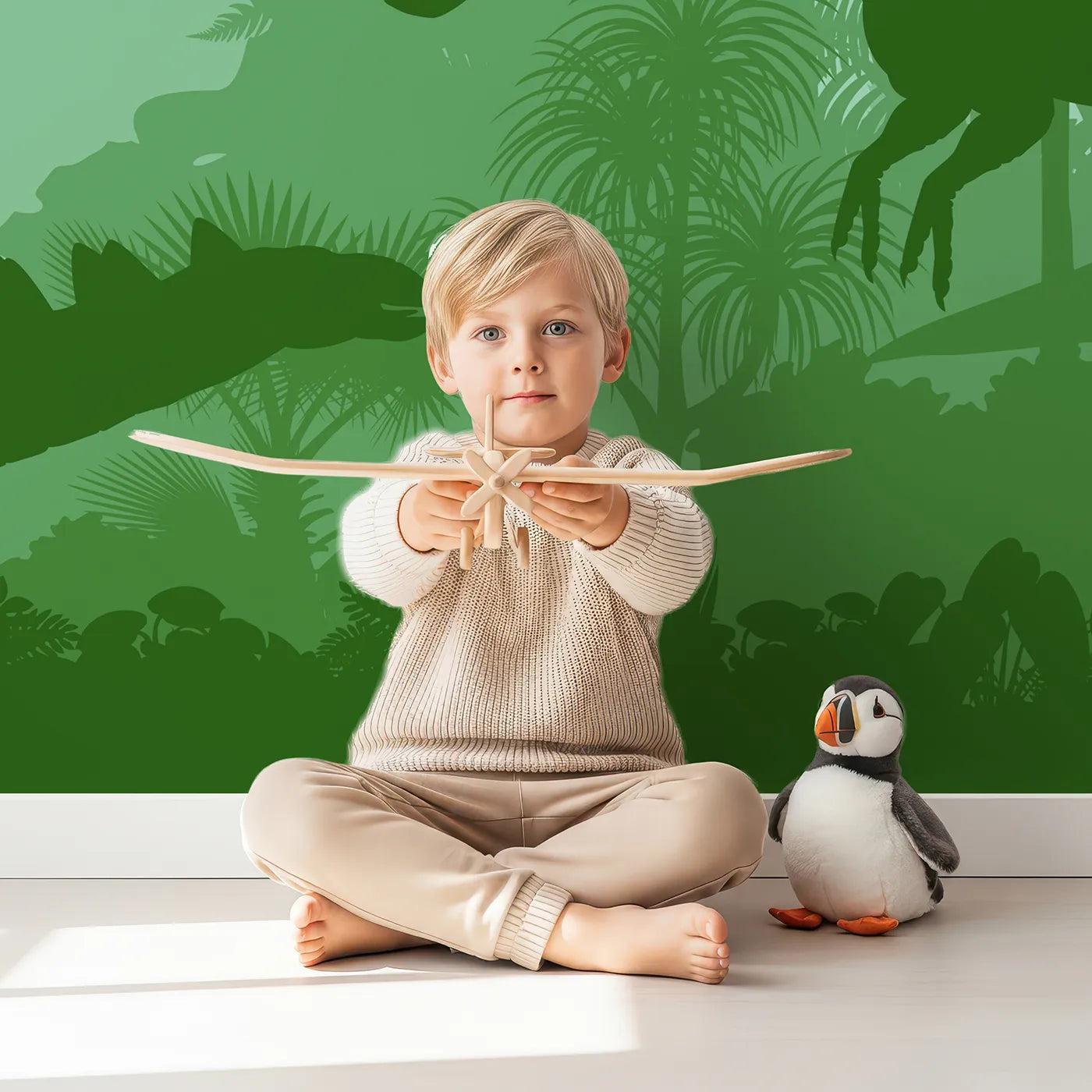 Child in front of Whimsy Tots Green Dinosaur Silhouette Wall Mural with dinosaur, silhouette, jungle, prehistoric, green, t-rex, nature, landscape in design.
