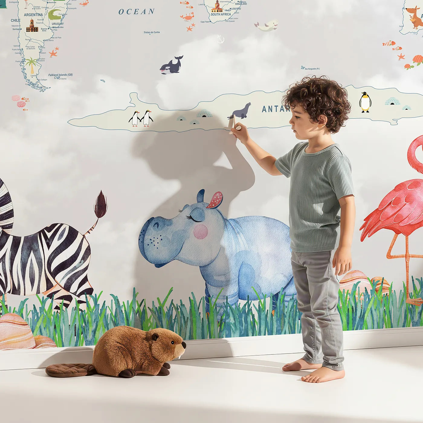 Child in front of Whimsy Tots Animal World Tour Wall Mural with map, world, animal, watercolor, safari, travel, balloon, airplane in design.