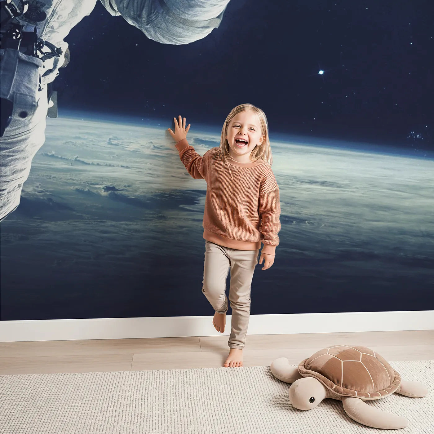 Child in front of Whimsy Tots Astronaut and Planets Wall Mural with space, astronaut, planet, realistic, galaxy, star, science, cosmos in design.