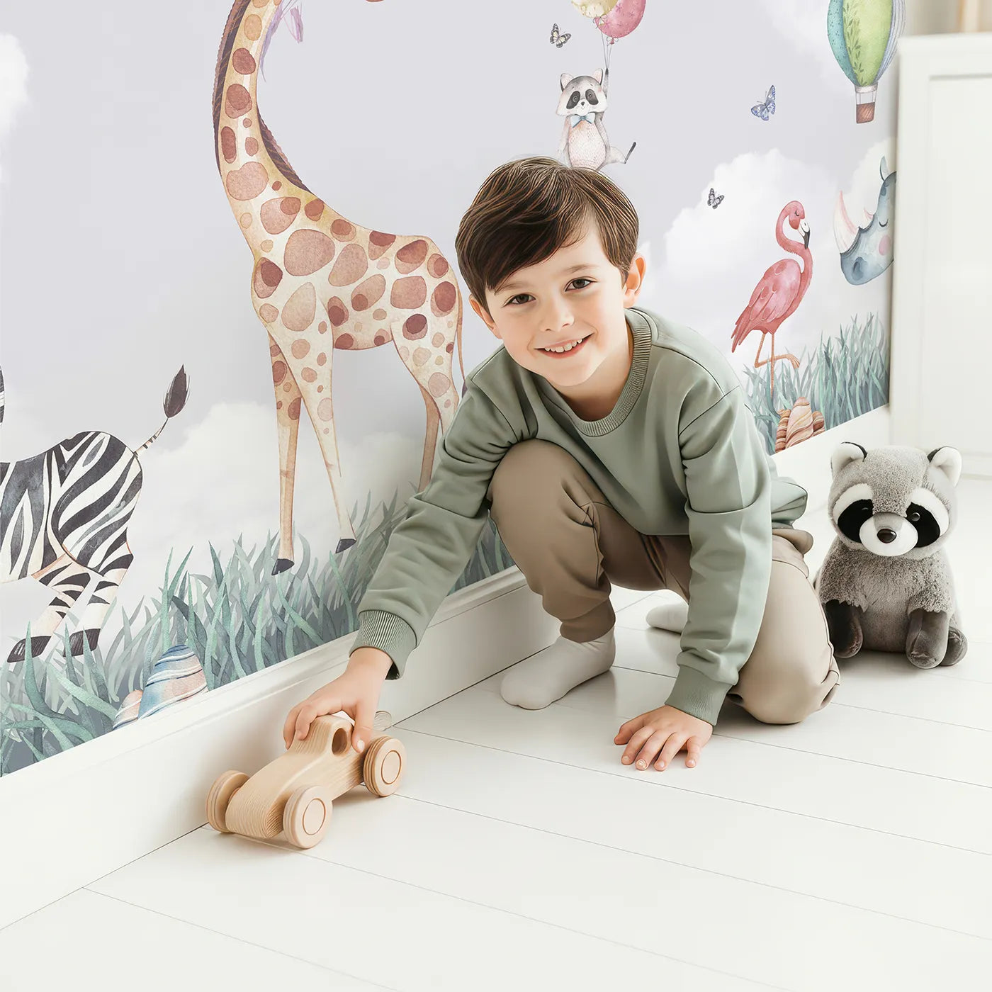 Child in front of Whimsy Tots Safari Sky Parade Wall Mural with animal, safari, balloon, cute, airplane, watercolor, sky, whimsical in design.