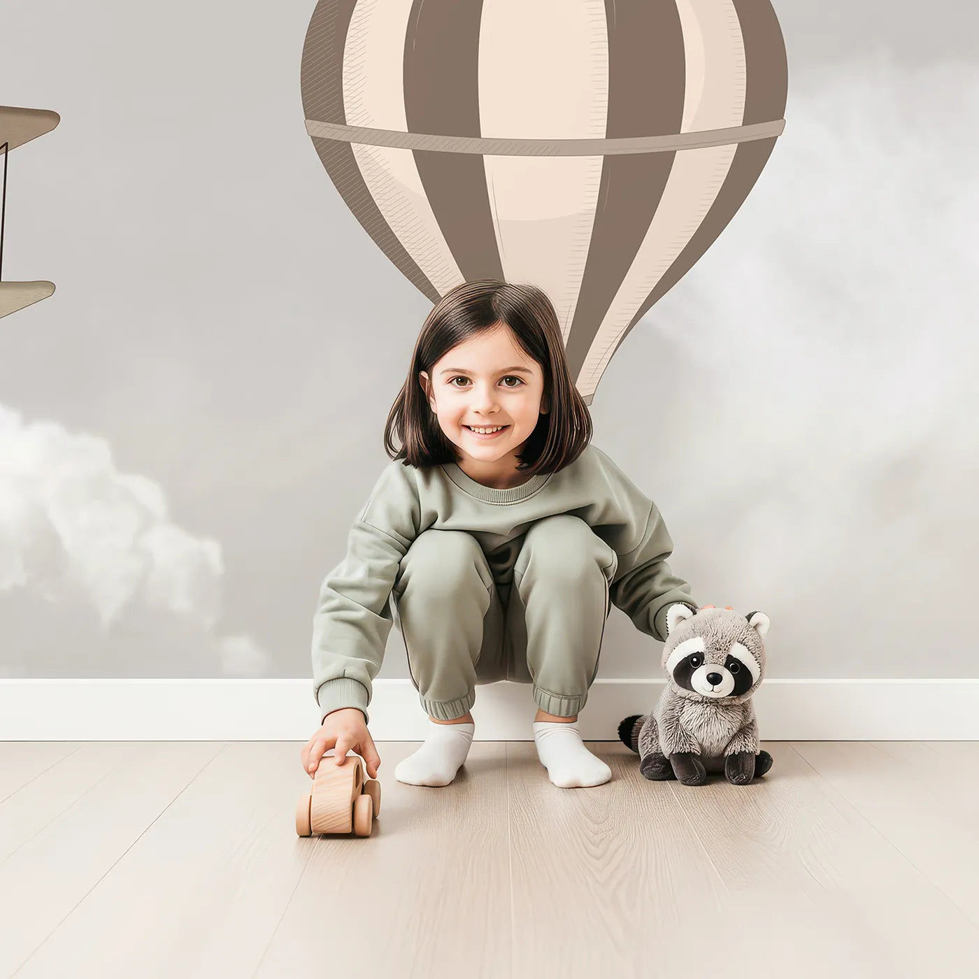 Child in front of Whimsy Tots Vintage Sky Fleet Wall Mural in Brown with airplane, balloon, vintage, cloud, sky, brown, retro, biplane in design.