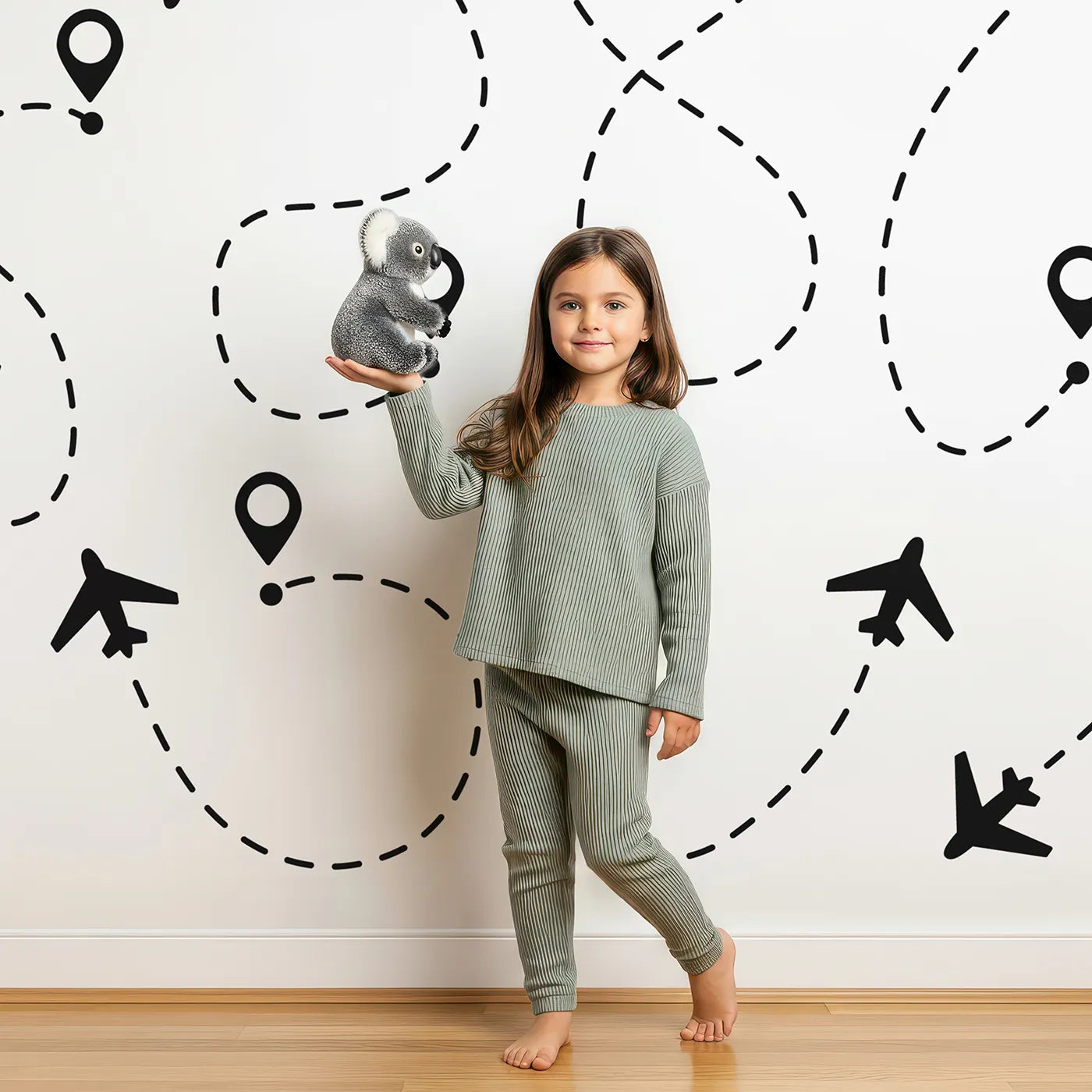 Child in front of Whimsy Tots Flight Paths Wall Mural with airplane, plane, sketch, black and white, pattern, travel, flight path, map in design.