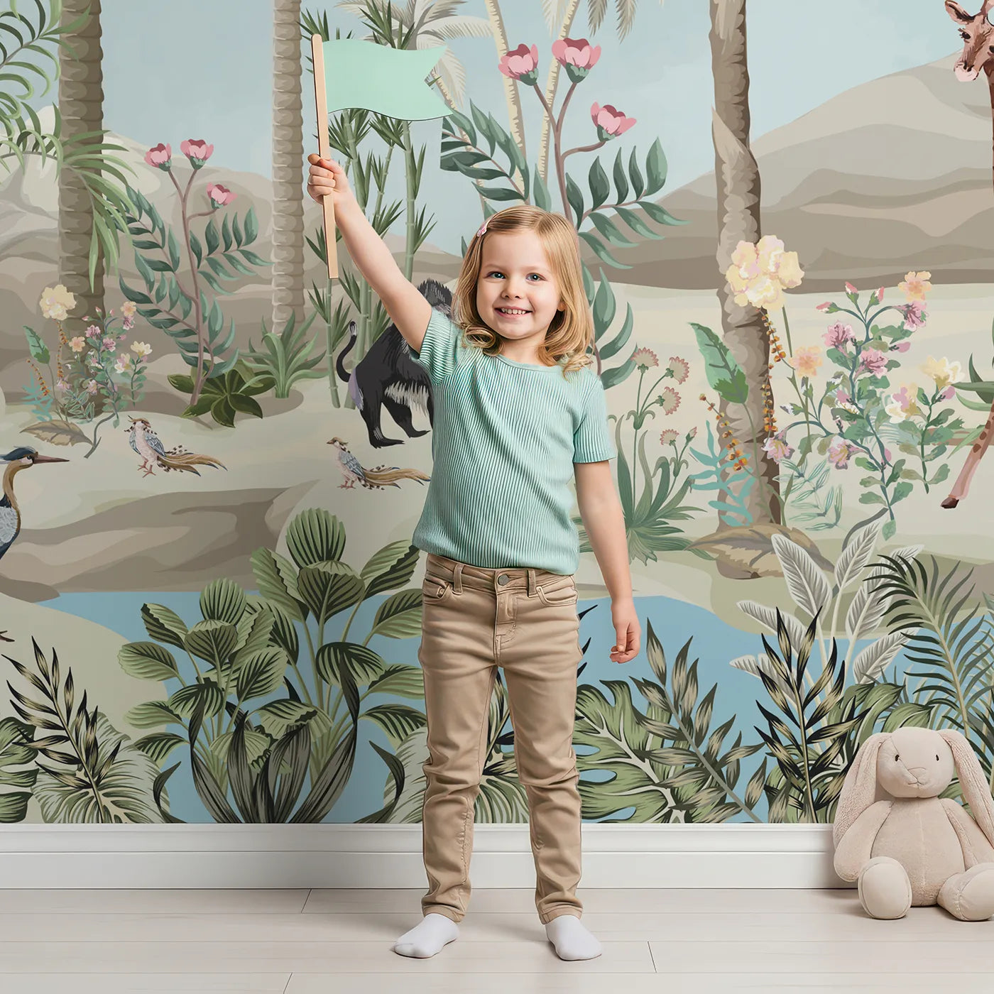 Child in front of Whimsy Tots Desert Oasis Wall Mural with safari, jungle, oasis, animal, giraffe, bird, tropical, vibrant in design.