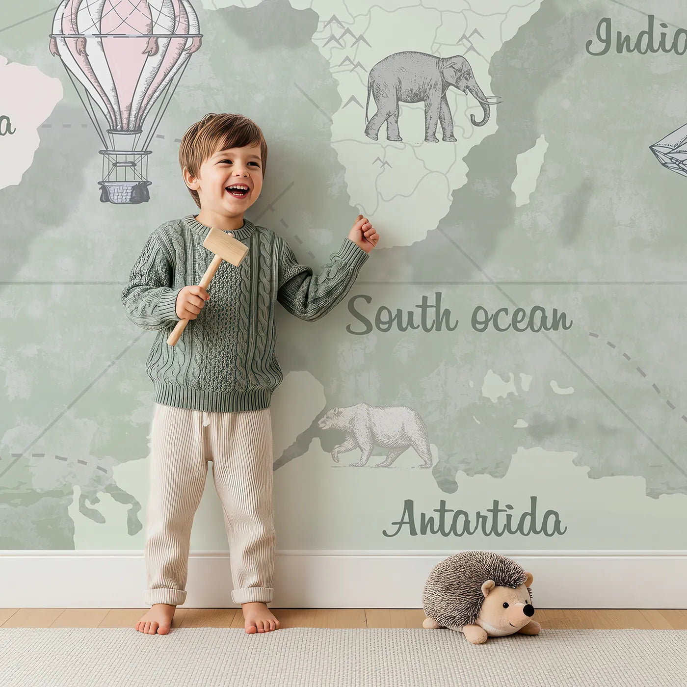 Child in front of Whimsy Tots Vintage Explorer World Map Wall Mural in Green with map, world, vintage, animal, travel, educational, ship, green in design.