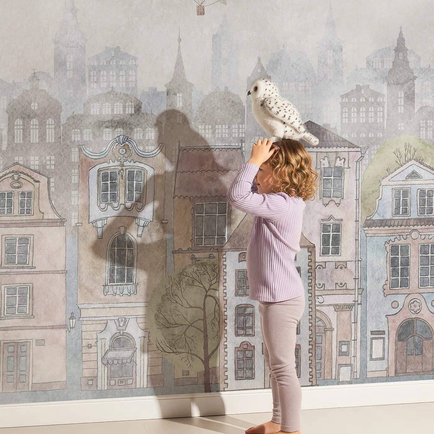 Child in front of Whimsy Tots Vintage City and World Map Wall Mural with map, world, vintage, city, travel, educational, balloon, european in design.