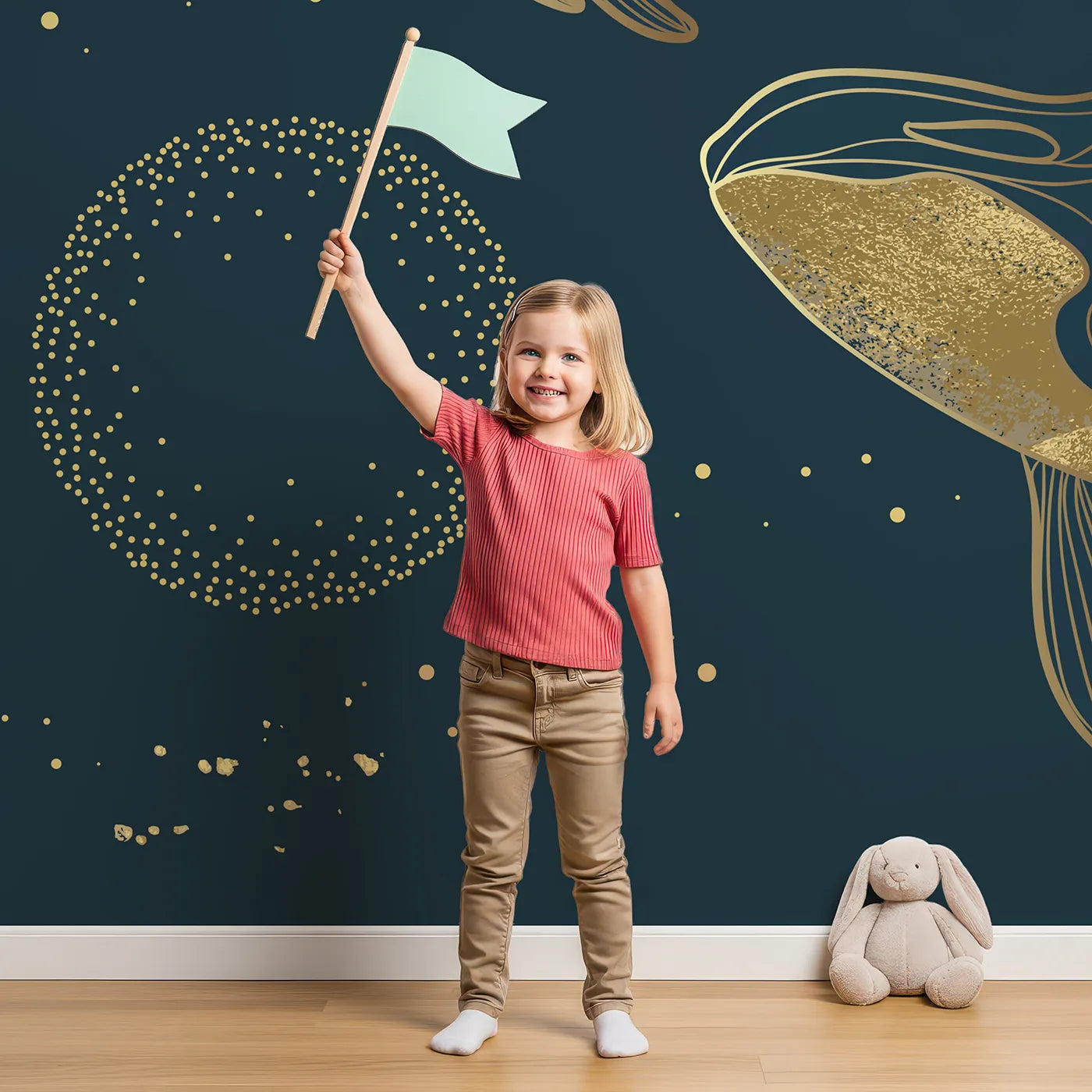 Child in front of Whimsy Tots Golden Cosmic Whales Wall Mural with whale, space, star, gold, line art, cosmic, celestial, modern in design.