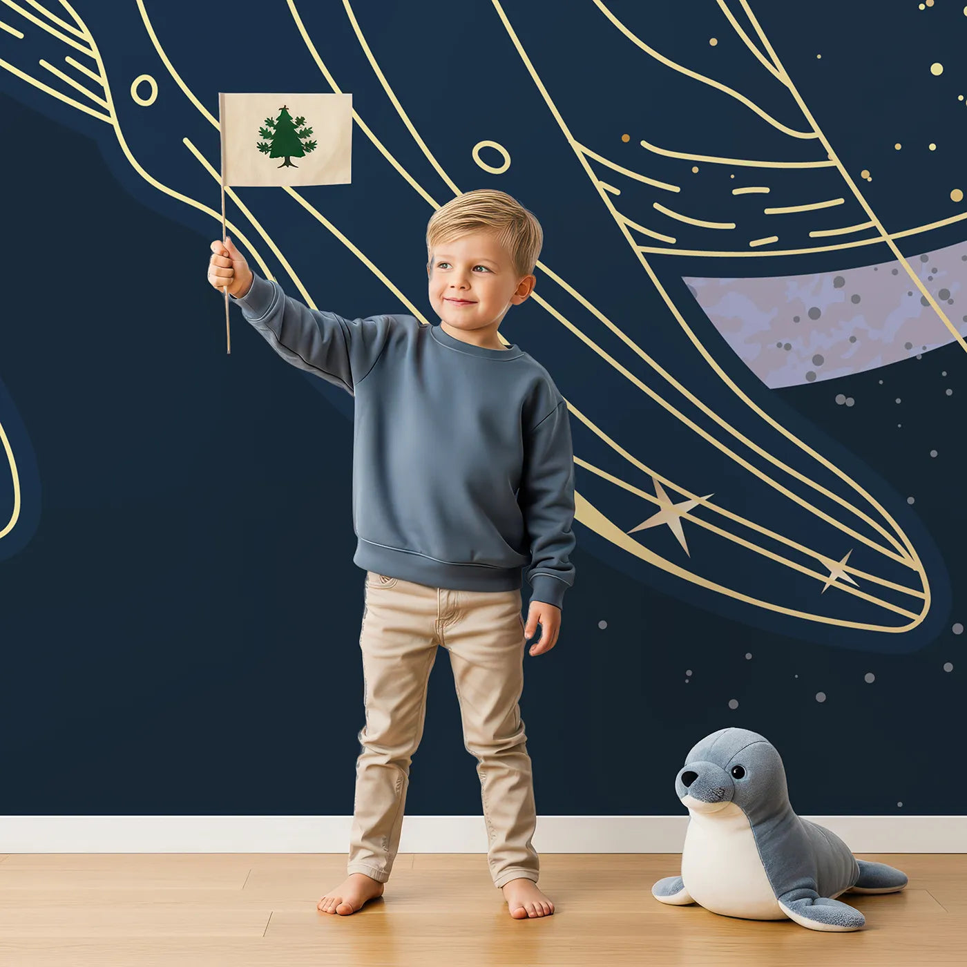 Child in front of Whimsy Tots Celestial Whale Wall Mural with whale, space, star, moon, gold, line art, cosmic, celestial in design.
