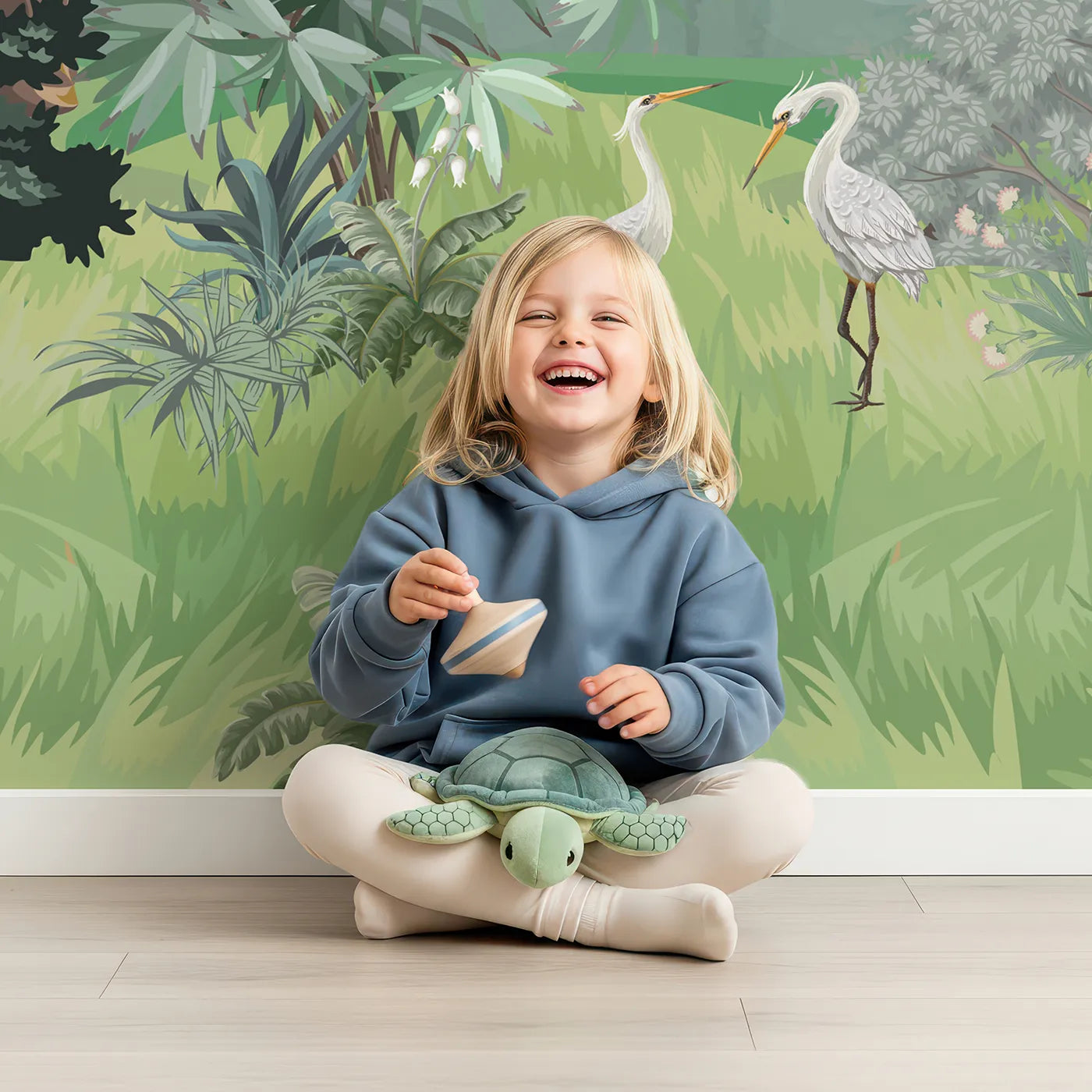 Child in front of Whimsy Tots Exotic Bird Sanctuary Wall Mural in Green with chinoiserie, vintage, bird, exotic, tropical, classic, garden, green in design.