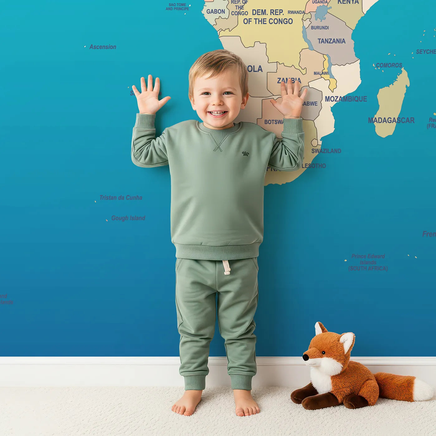 Child in front of Whimsy Tots Political World Map Wall Mural with map, world, political, country, educational, travel, geography, ocean in design.