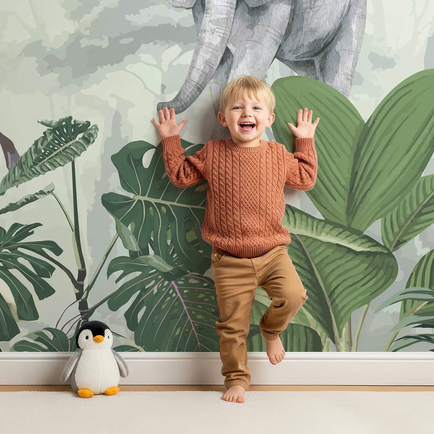 Child in front of Whimsy Tots Jungle Gathering Wall Mural in Green with safari, jungle, animal, realistic, elephant, giraffe, monkey, gorilla in design.