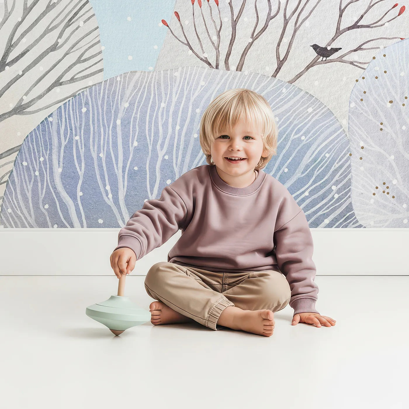 Child in front of Whimsy Tots Snowy Forest Wall Mural with winter, forest, snow, tree, painted, artistic, landscape, blue in design.