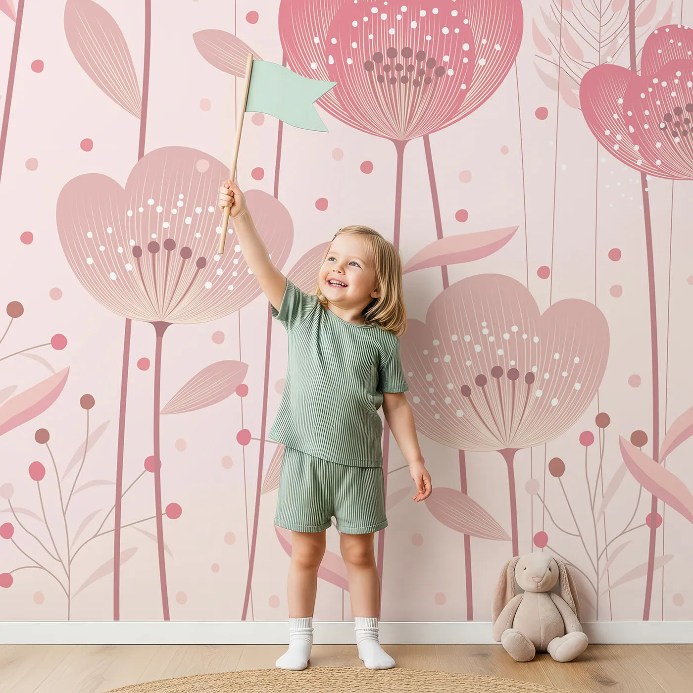Child in front of Whimsy Tots Pink Flower Meadow Wall Mural with flower, wildflower, pink, painterly, floral, garden, romantic, modern in design.