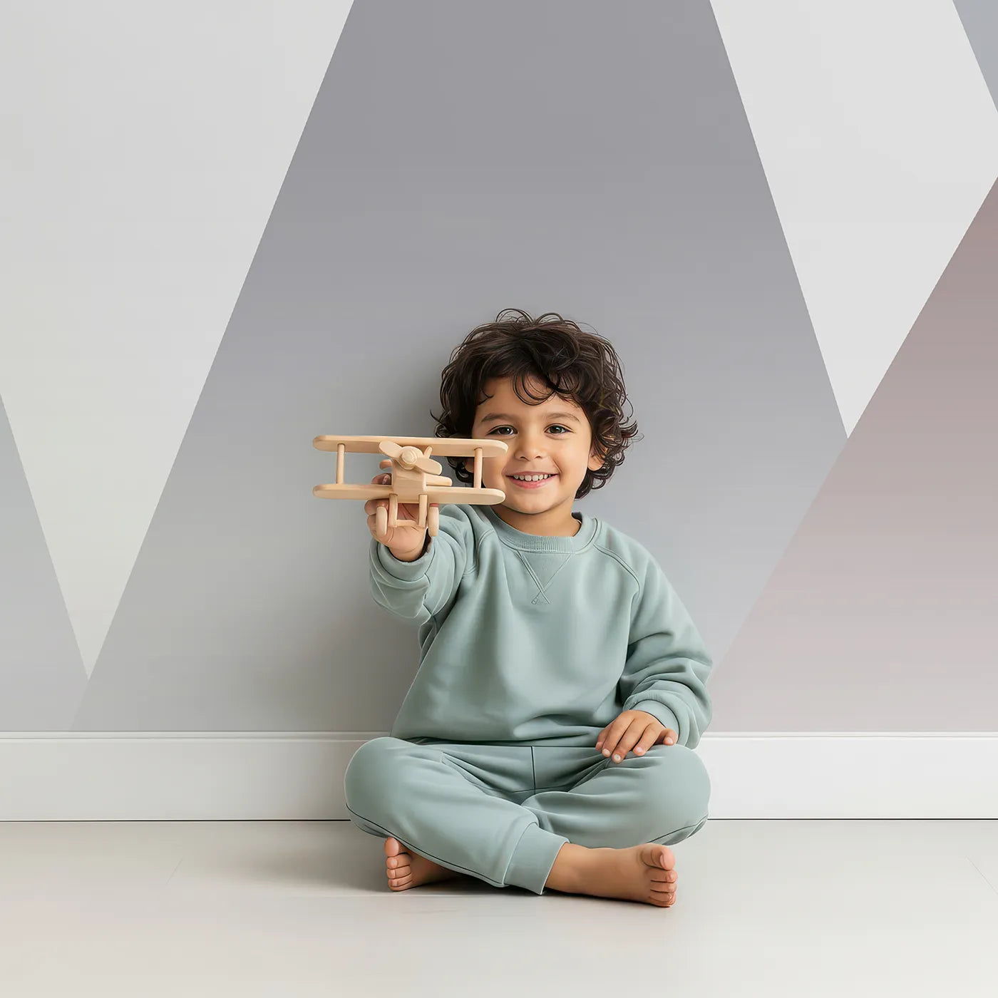 Child in front of Whimsy Tots Singing Mountains Wall Mural with mountain, sleep, moon, cute, gray, nursery, music, balloon in design.