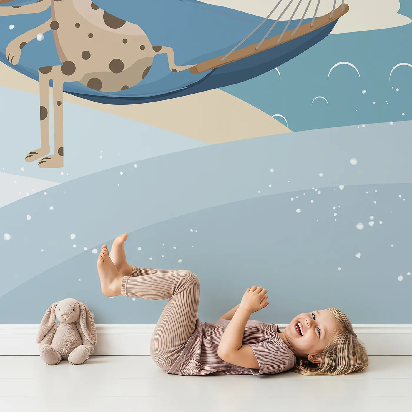 Child in front of Whimsy Tots Winter Safari Adventure Wall Mural with animal, safari, winter, snow, airplane, cute, mountain, giraffe in design.