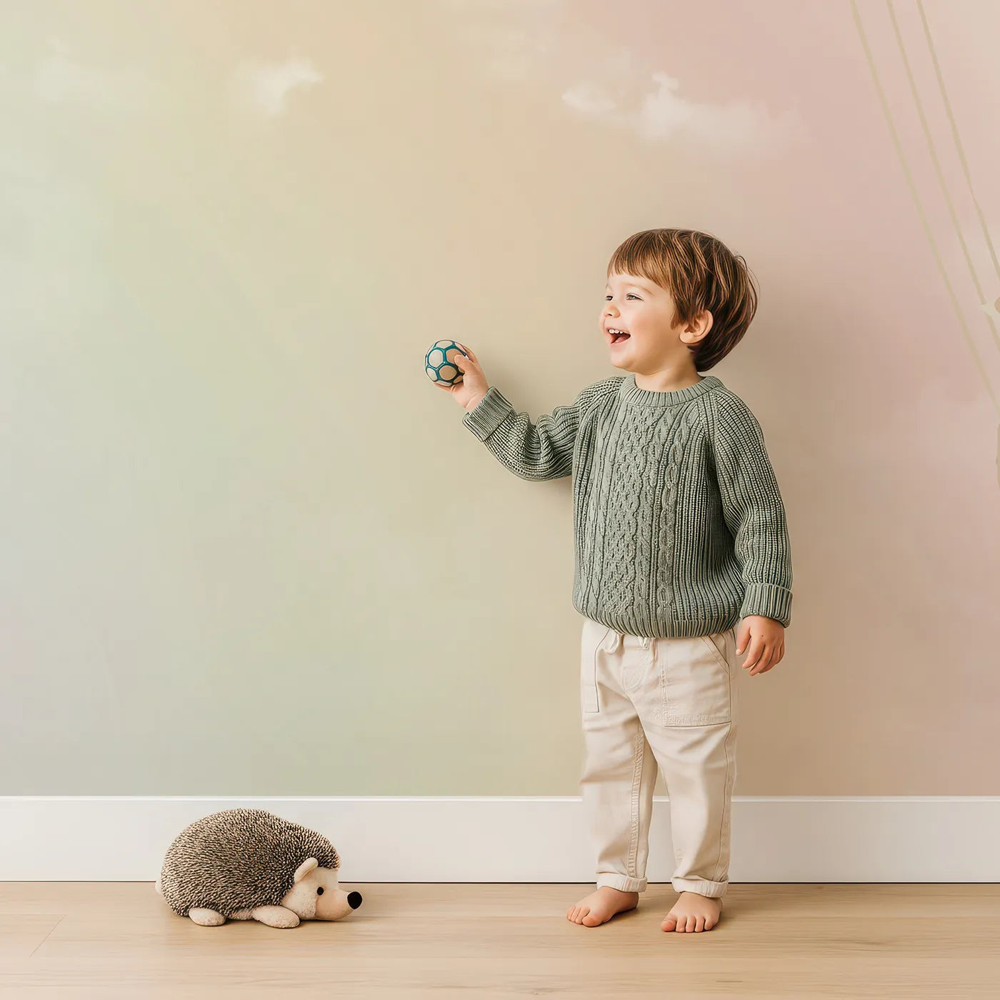 Child in front of Whimsy Tots Pastel Sky Balloon Adventure Wall Mural with balloon, hot air balloon, sky, cloud, pastel, pink, blue, cute in design.