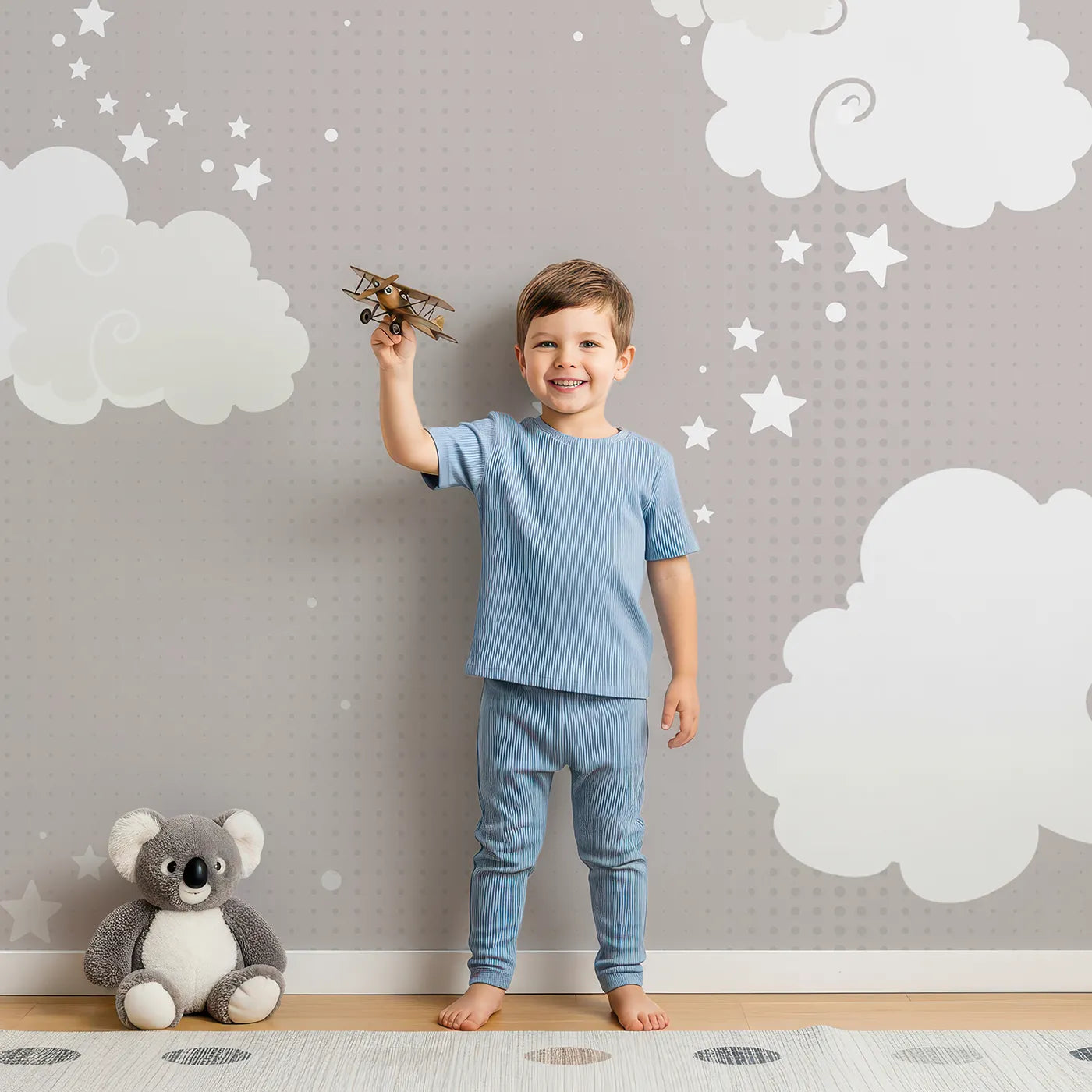 Child in front of Whimsy Tots Starry Sky Banner Plane Wall Mural with airplane, plane, sky, star, cute, modern, gray, banner in design.