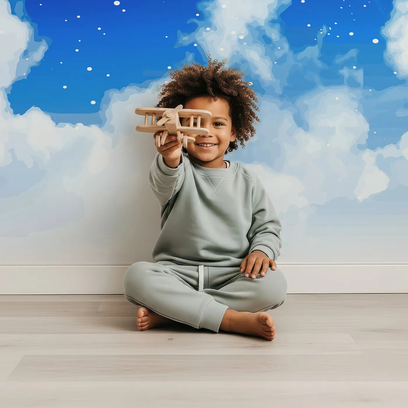Child in front of Whimsy Tots Starry Night Sky Wall Mural with star, night, sky, space, moon, galaxy, universe, blue in design.