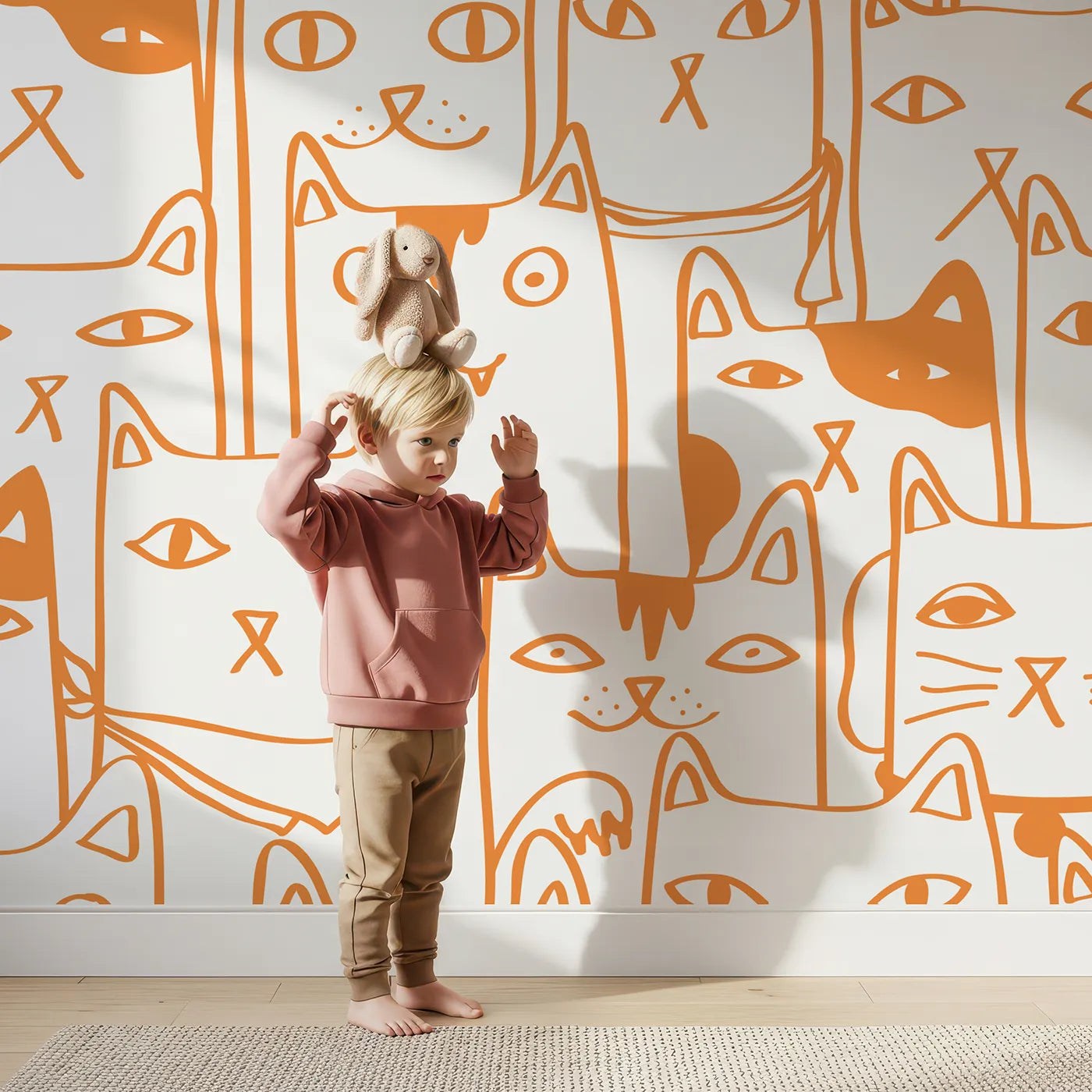 Child in front of Whimsy Tots Orange Cat Doodle Wall Mural with cat, kitten, doodle, orange, white, pattern, cute, animal in design.