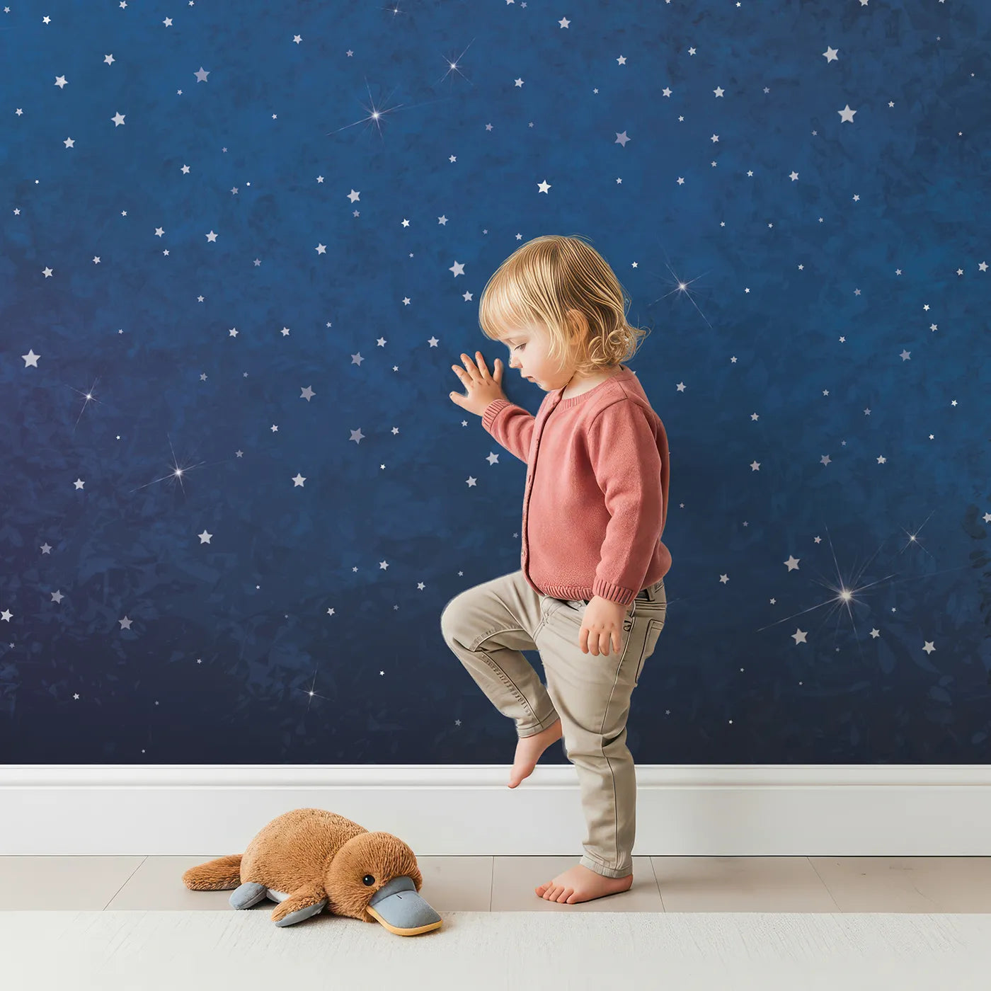 Child in front of Whimsy Tots Deep Space Wall Mural with star, night, sky, space, galaxy, universe, blue, deep space in design.