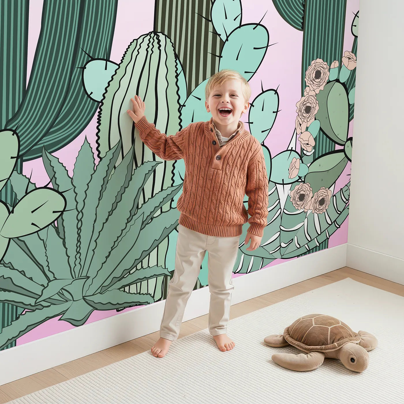Child in front of Whimsy Tots Cactus Garden Border Wall Mural with cactus, succulent, desert, nature, plant, botanical, boho in design.