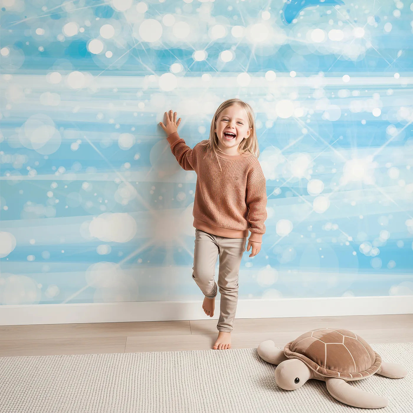 Child in front of Whimsy Tots Sparkling Dolphin Bay Wall Mural with dolphin, sea, ocean, sparkle, water, blue, magical, summer in design.