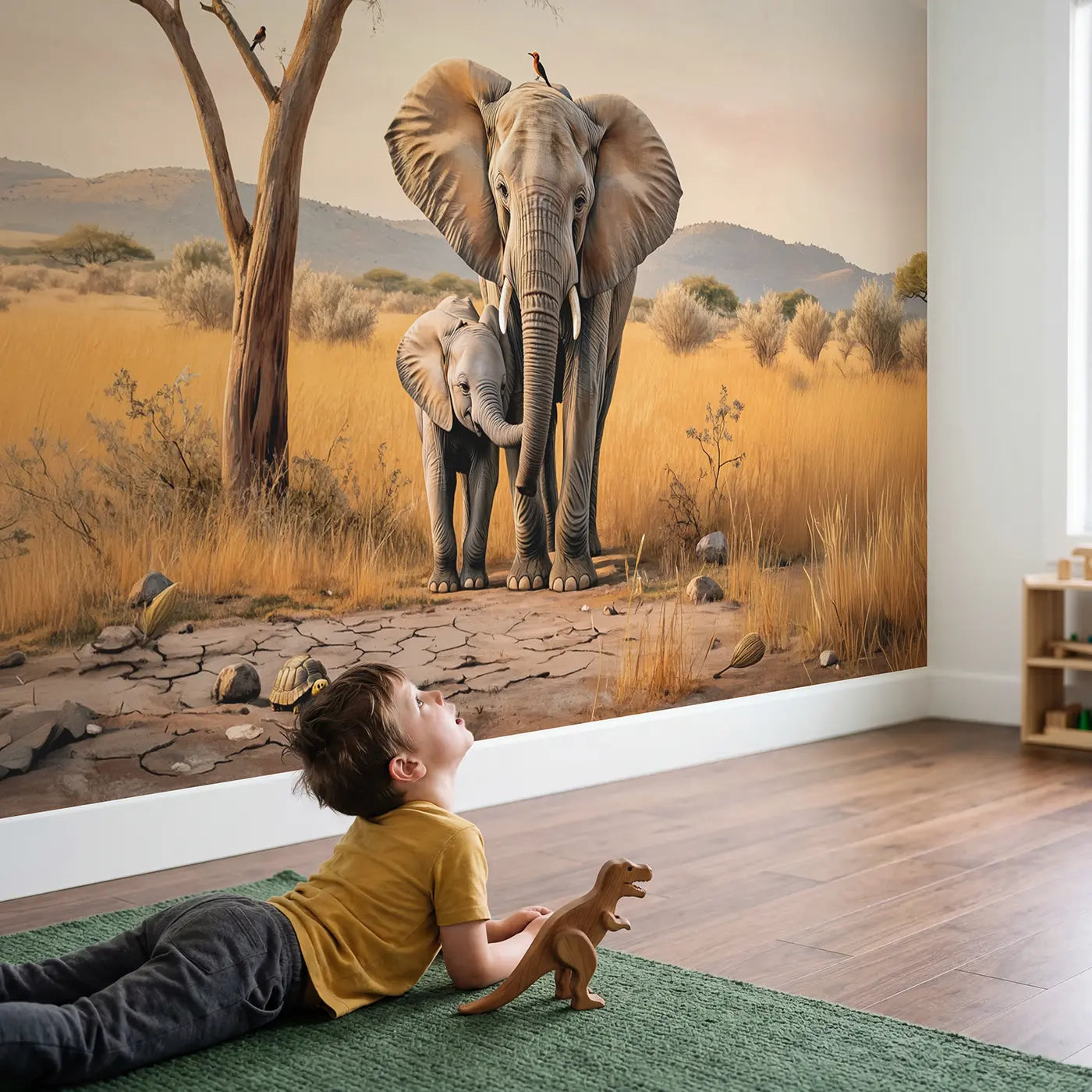 Child in nursery with Sleepy Elephant Nursery Wallpaper Mural by Whimsy Tots