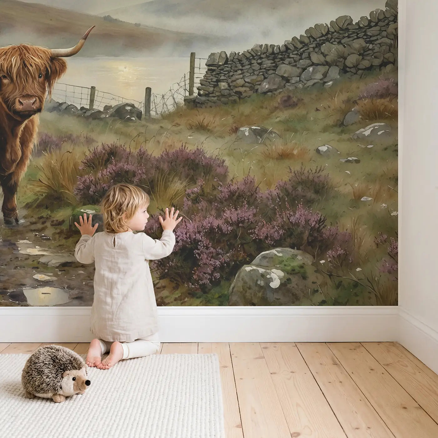 Child in nursery with Misty Highland Cow Wallpaper Mural by Whimsy Tots