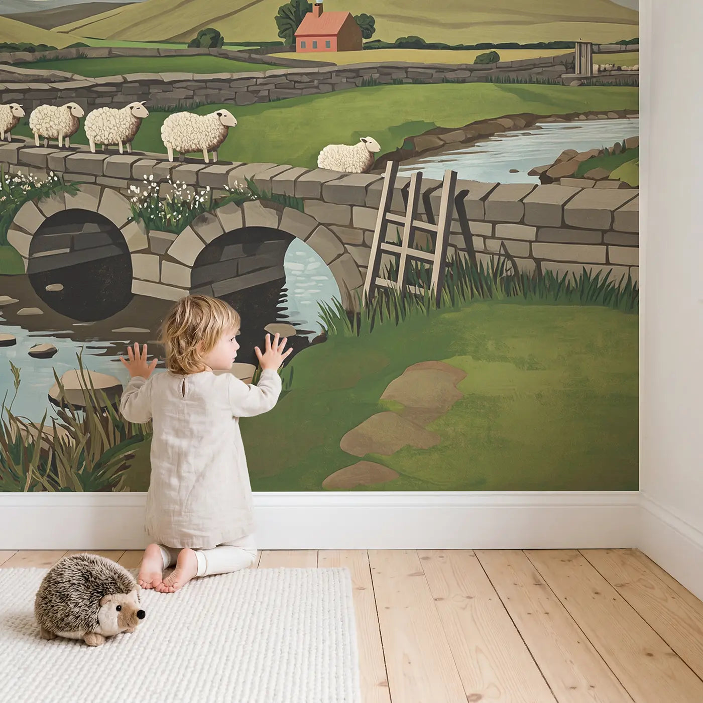 Child in nursery with Woolly Sheep Bridge Wallpaper Mural by Whimsy Tots