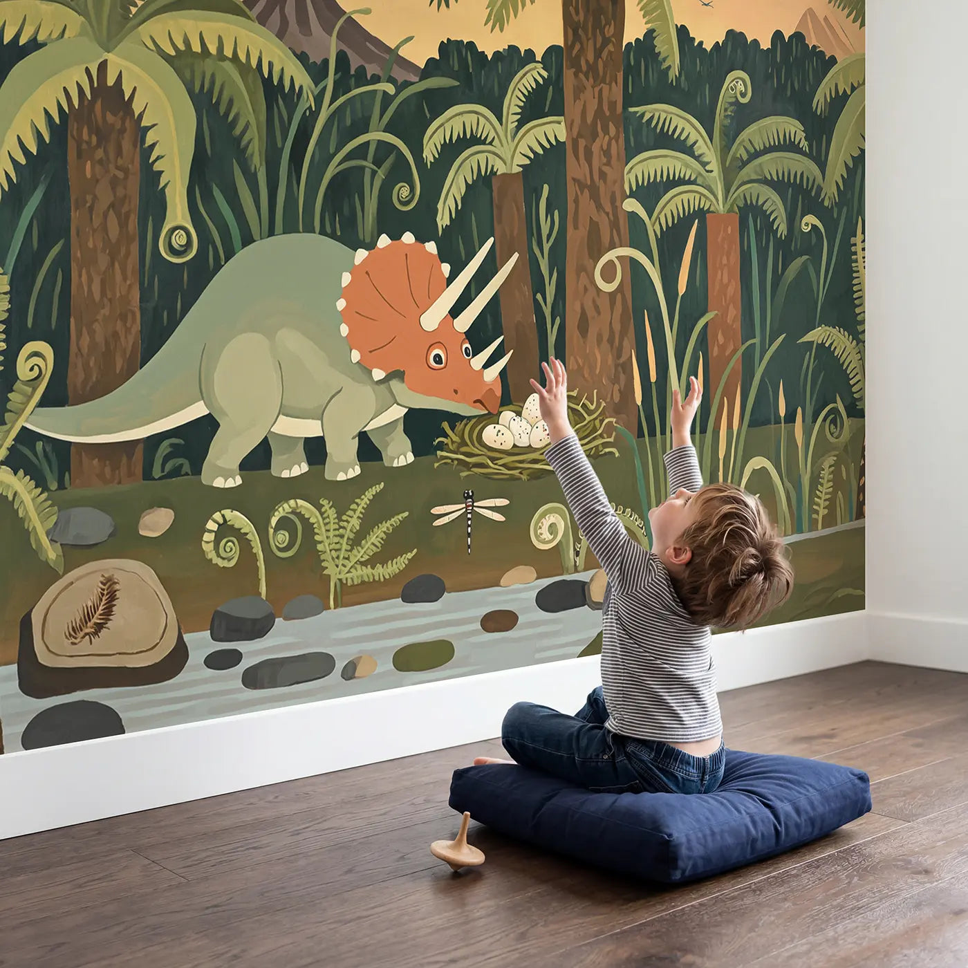Child in nursery with Friendly Triceratops Jungle Wallpaper Mural by Whimsy Tots