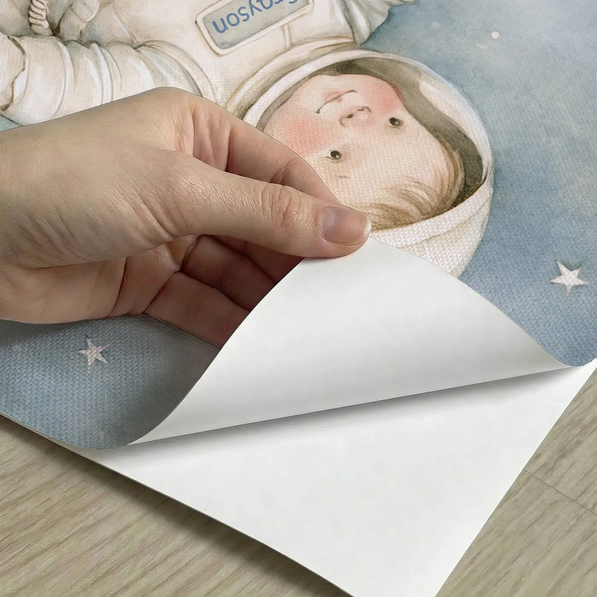 Peel-and-stick detail of Floating Astronaut Space Personalized Wall Mural by Whimsy Tots