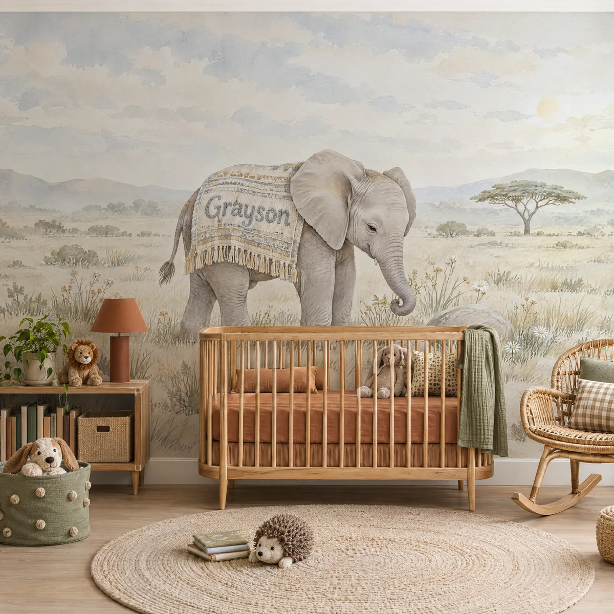 Watercolor personalized wall mural of a little elephant in a name blanket, in a styled room, by Whimsy Tots