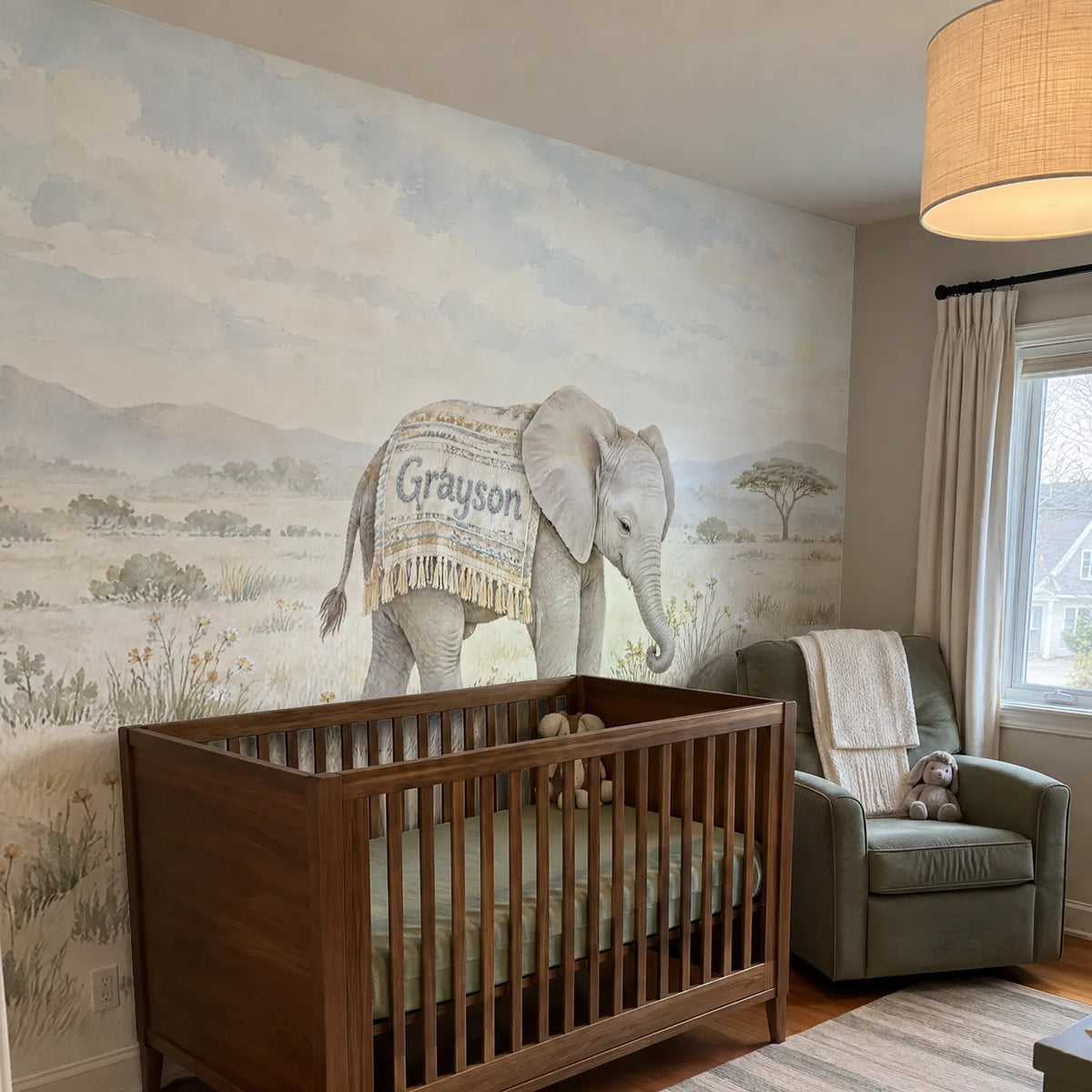 Watercolor personalized wall mural of a little elephant in a name blanket, in a room photo, by Whimsy Tots