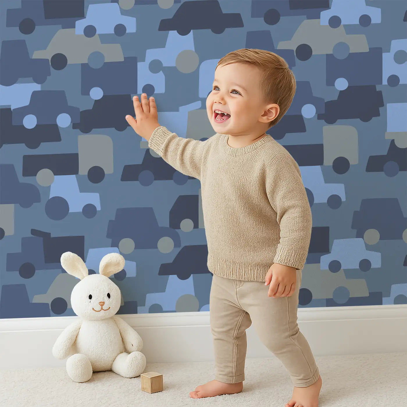 Child in front of Whimsy Tots Urban Wheels Wallpaper with car, truck, bus, camo, wheel in design.