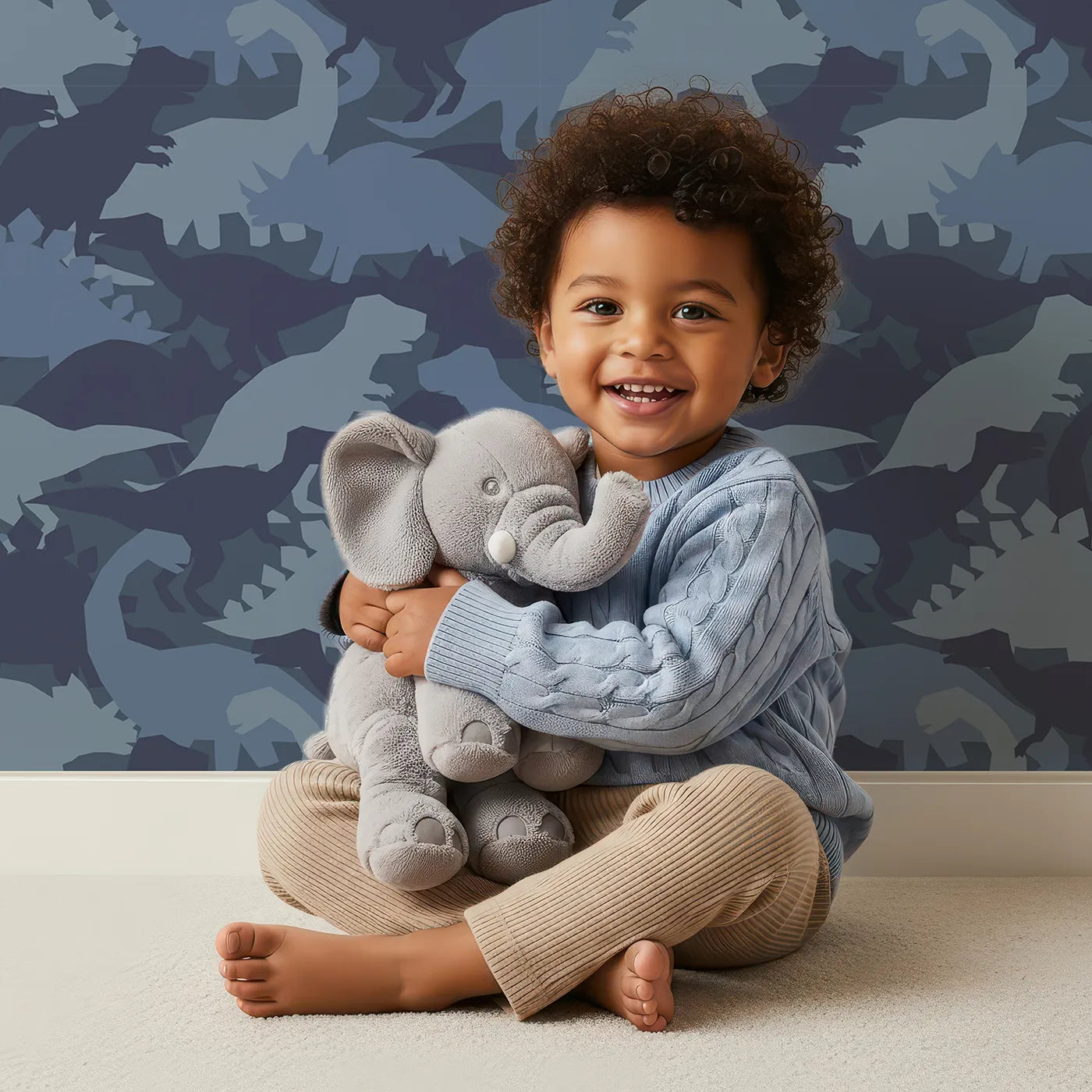 Lovely child standing in front of Whimsy Tots Dinosaur Camouflage Wallpaper in Blue with dinosaur, camouflage, t-rex, stegosaurus, silhouette in design.