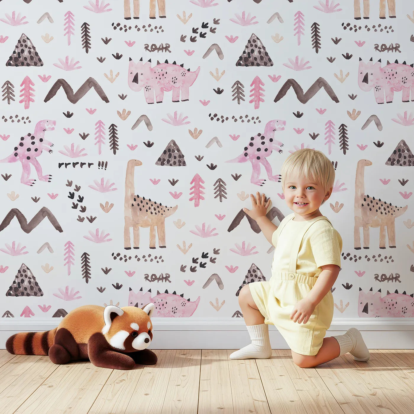 Lovely child standing in front of Whimsy Tots Watercolor Dino Land Wallpaper in Pink with dinosaur, watercolor, pink, mountain, roar in design.