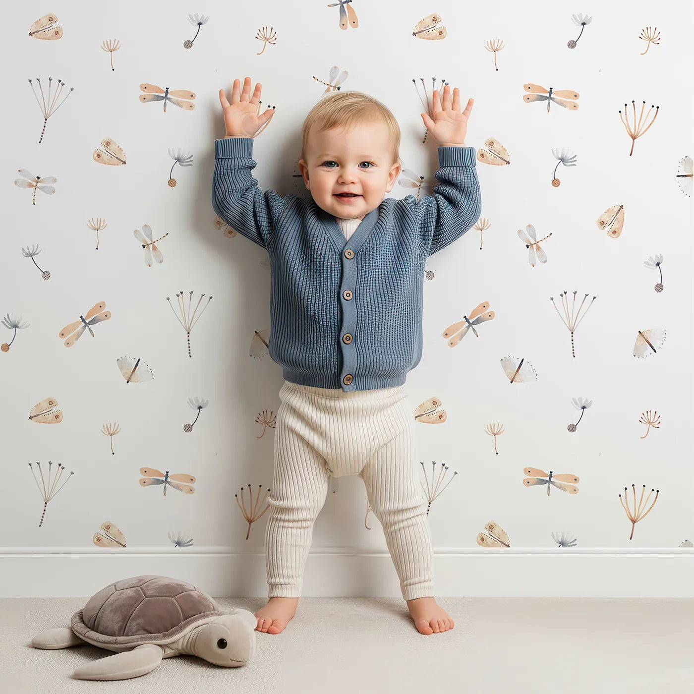 Lovely child standing in front of Whimsy Tots Watercolor Dragonfly Garden Wallpaper with dragonfly, butterfly, dandelion, watercolor, botanical in design.