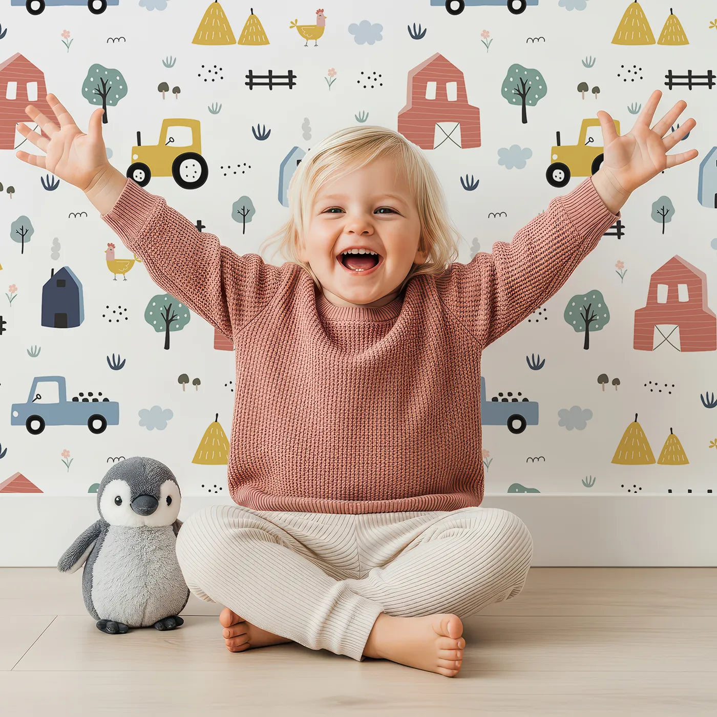 Lovely child standing in front of Whimsy Tots Scandinavian Farm Life Wallpaper with farm, barn, tractor, truck, scandinavian in design.
