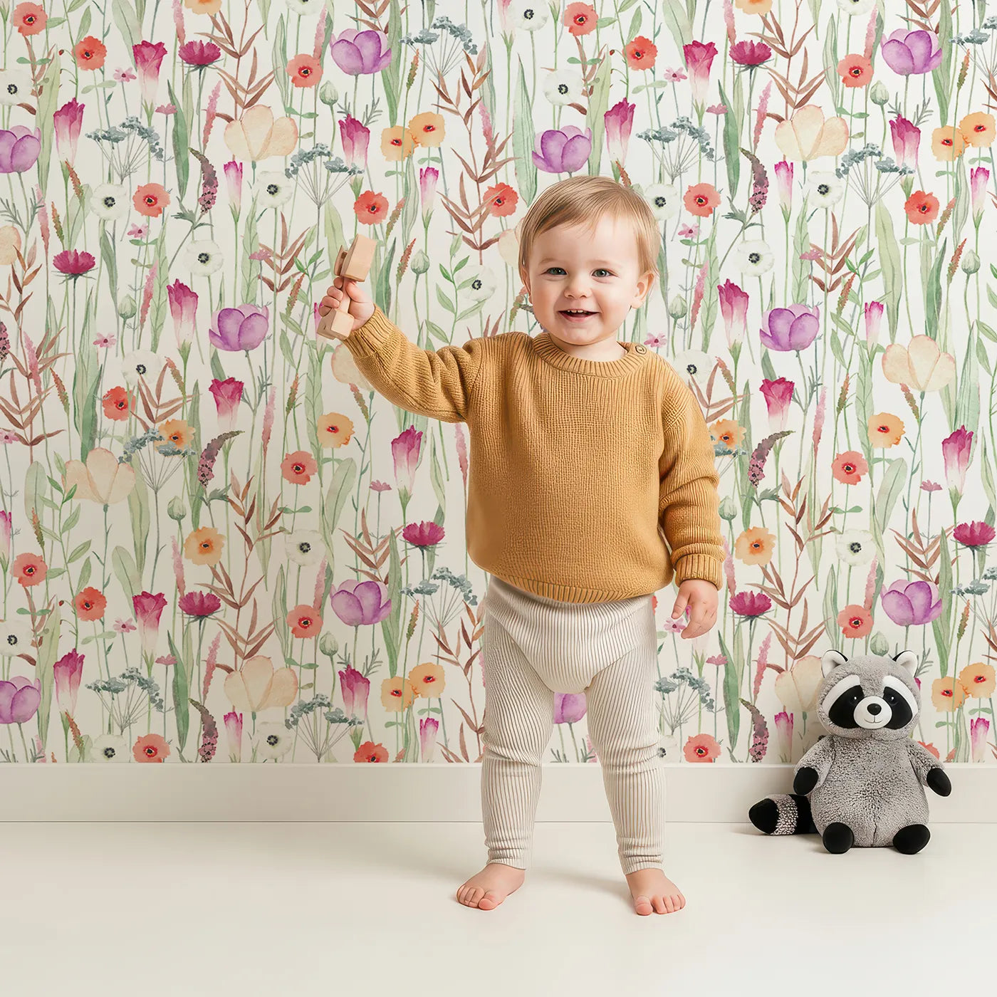 Lovely child standing in front of Whimsy Tots Colorful Wildflower Meadow Wallpaper with flower, wildflower, watercolor, botanical, meadow in design.