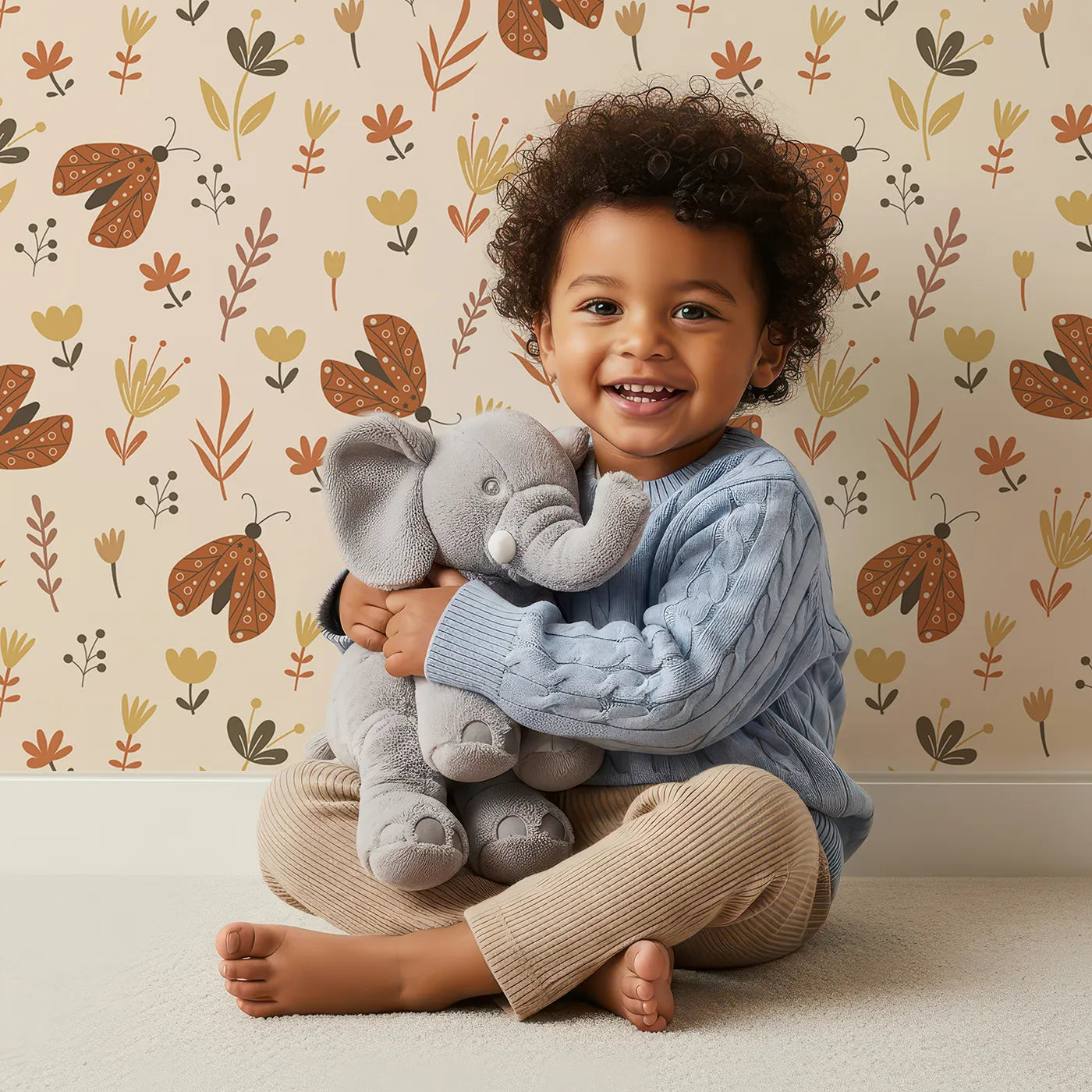 Lovely child standing in front of Whimsy Tots Boho Moth Meadow Wallpaper with moth, butterfly, flower, boho, botanical in design.