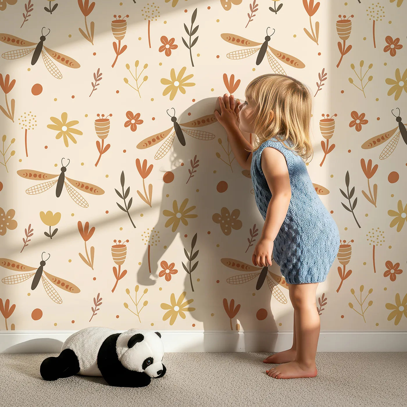 Lovely child standing in front of Whimsy Tots Boho Dragonfly Garden Wallpaper with dragonfly, flower, boho, botanical, insect in design.