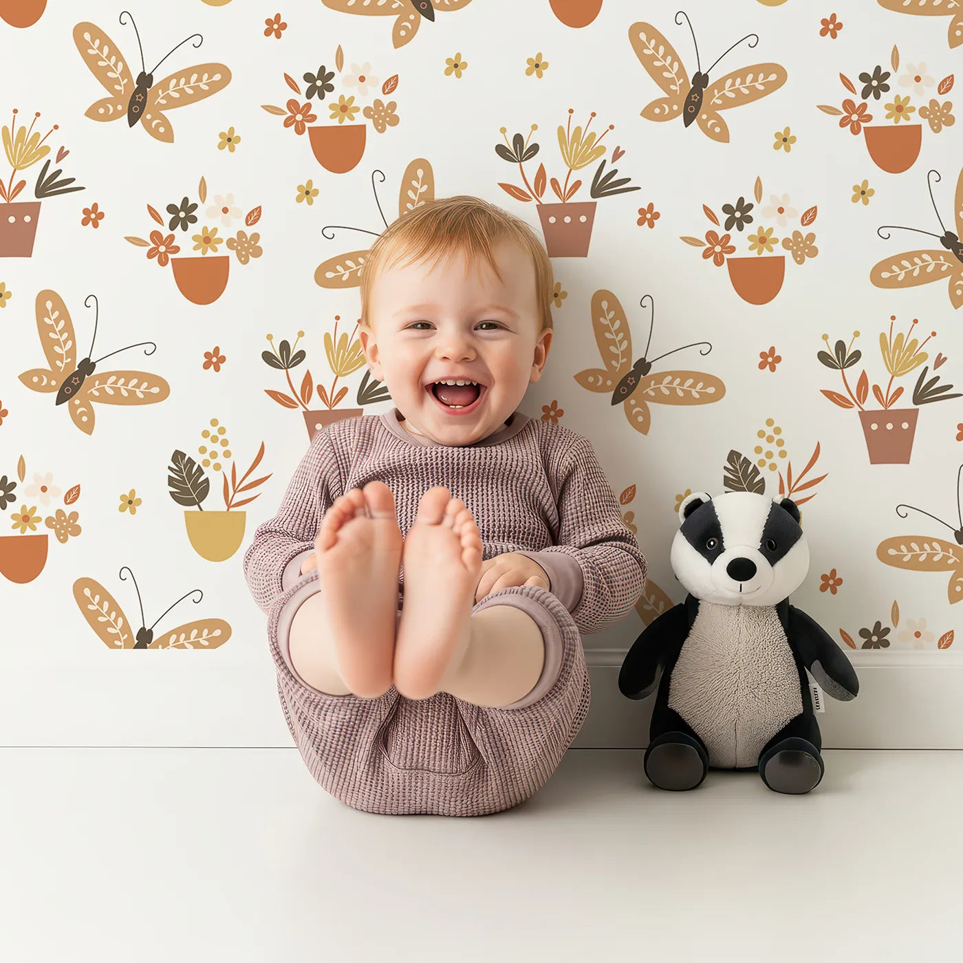 Lovely child standing in front of Whimsy Tots Boho Butterfly Garden Wallpaper with butterfly, flower, pot, boho, botanical in design.