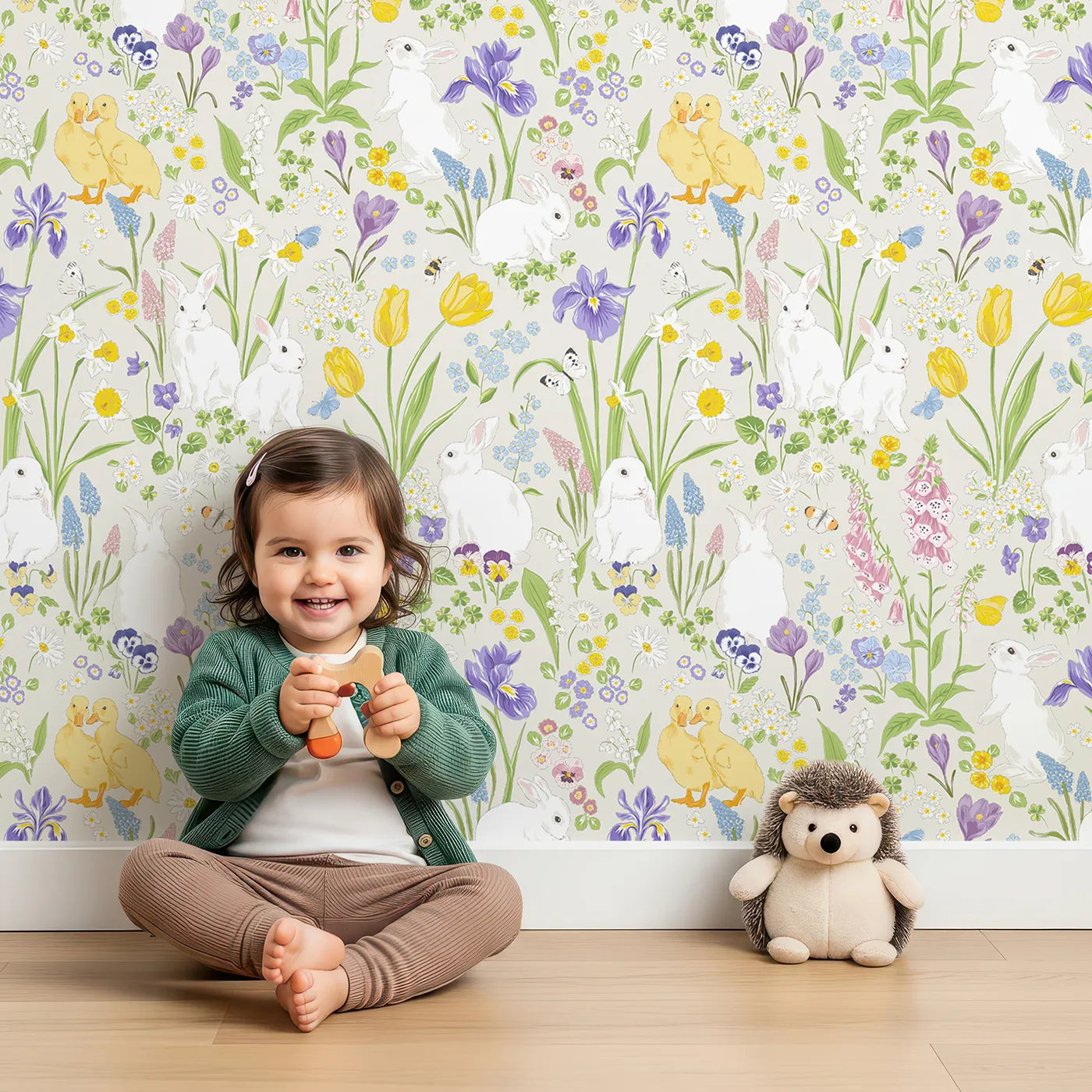 Lovely child standing in front of Whimsy Tots Spring Meadow Bunnies Wallpaper with bunny, rabbit, flower, spring, duckling in design.