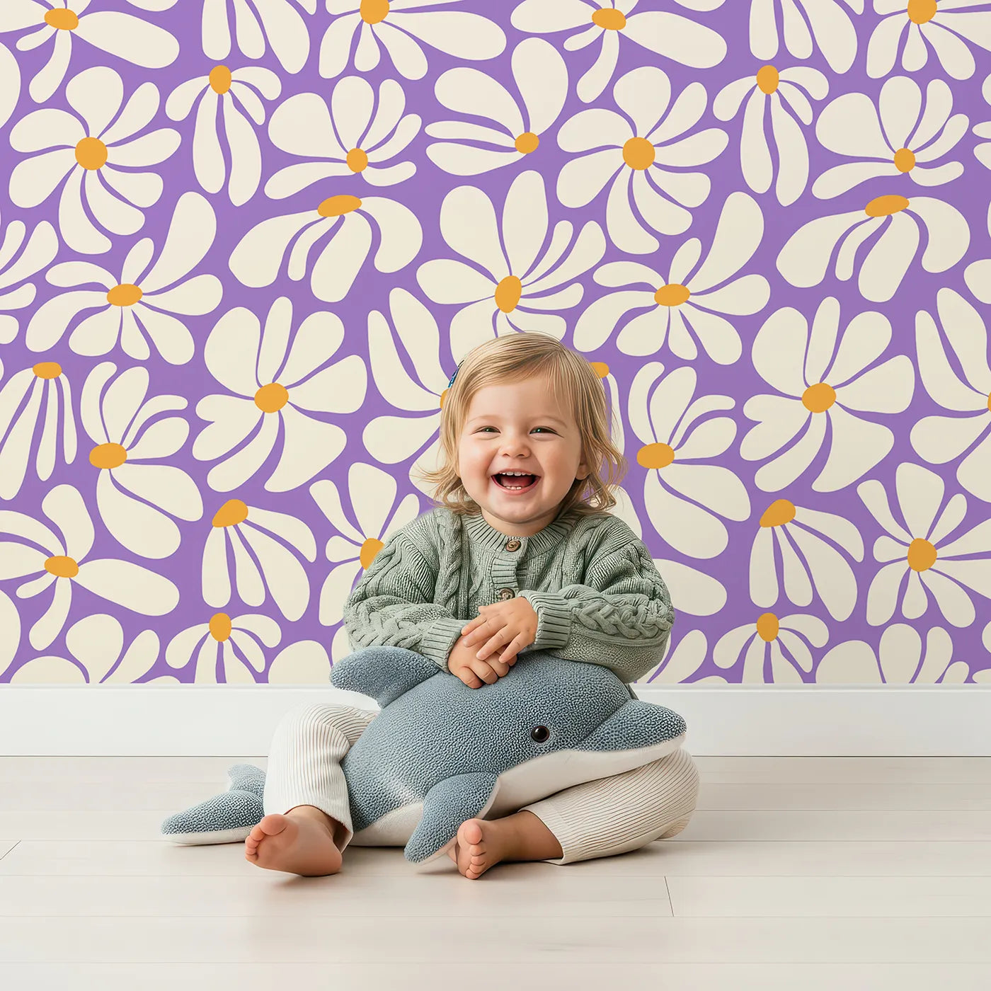 Lovely child standing in front of Whimsy Tots Groovy Daisy Wallpaper in Purple with daisy, flower, retro, 70s, purple in design.