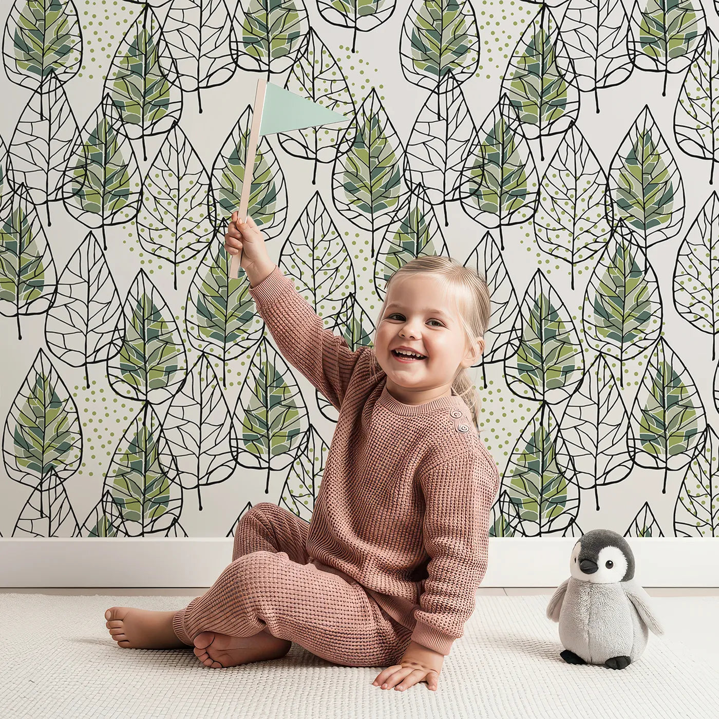 Lovely child standing in front of Whimsy Tots Modern Stained Glass Leaves Wallpaper with leaf, geometric, modern, stained glass, green in design.