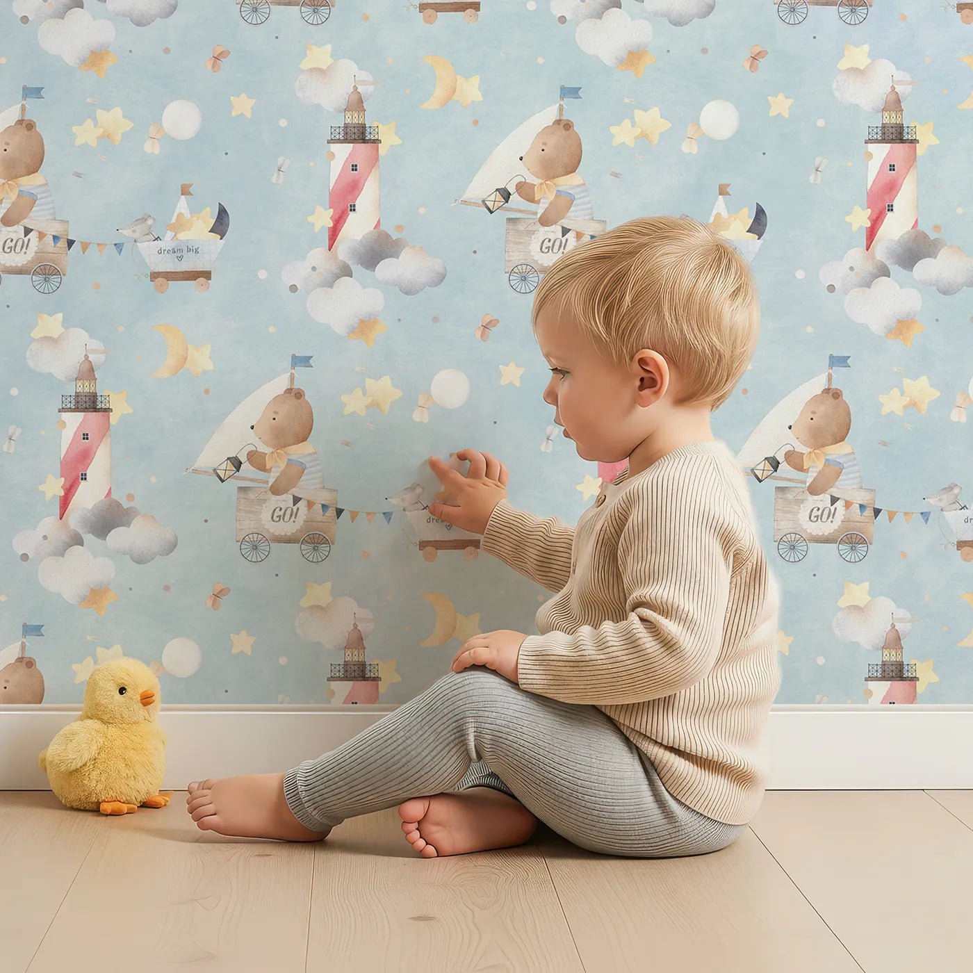 Lovely child standing in front of Whimsy Tots Dream Big Sky Adventure Wallpaper with bear, mouse, sky, star, moon in design.